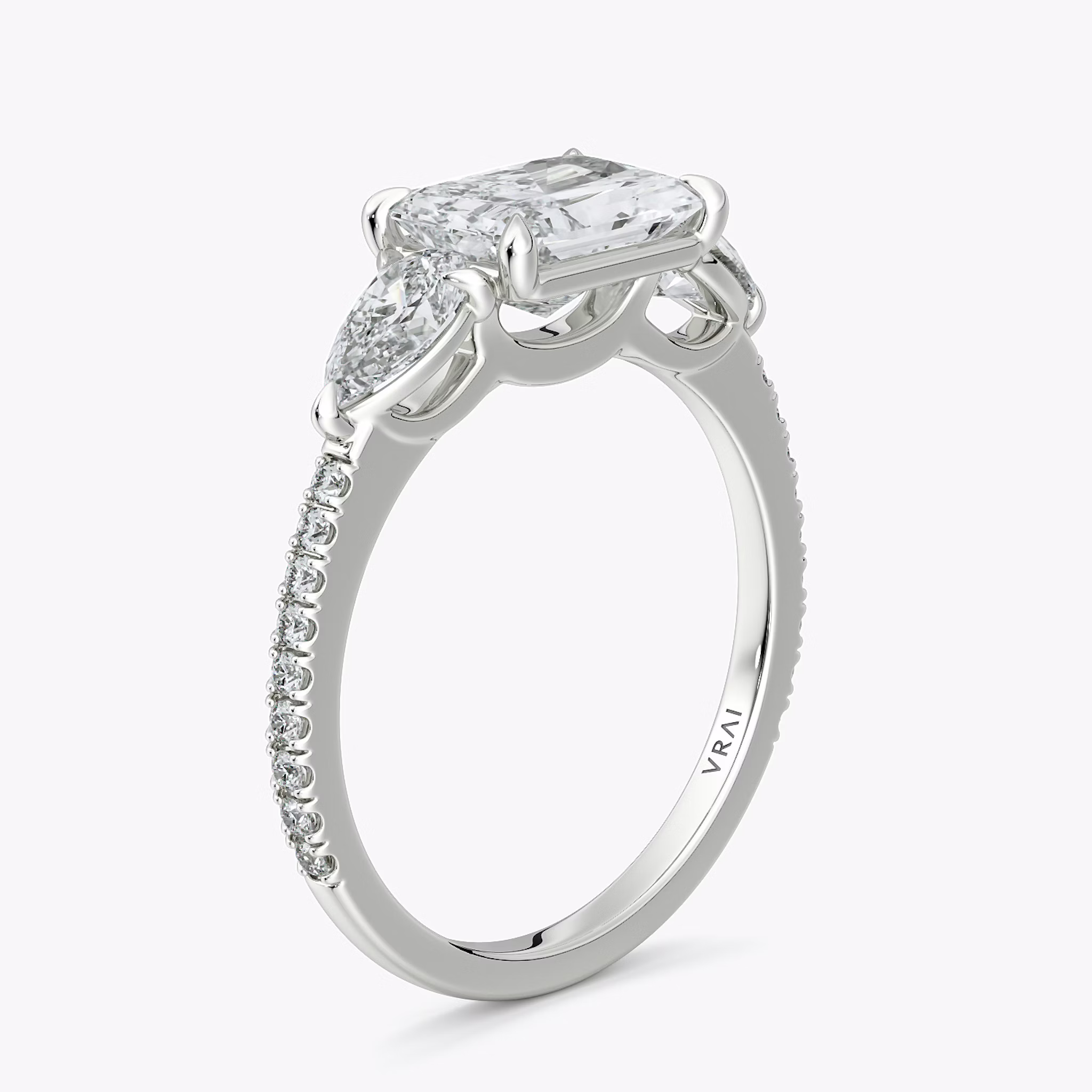 The Three Stone | Radiant | 18k | White Gold | bandAccent: Pavé | diamondOrientation: horizontal | sideStoneCarat: 0.25ct | sideStoneShape: Pear | caratWeight: other