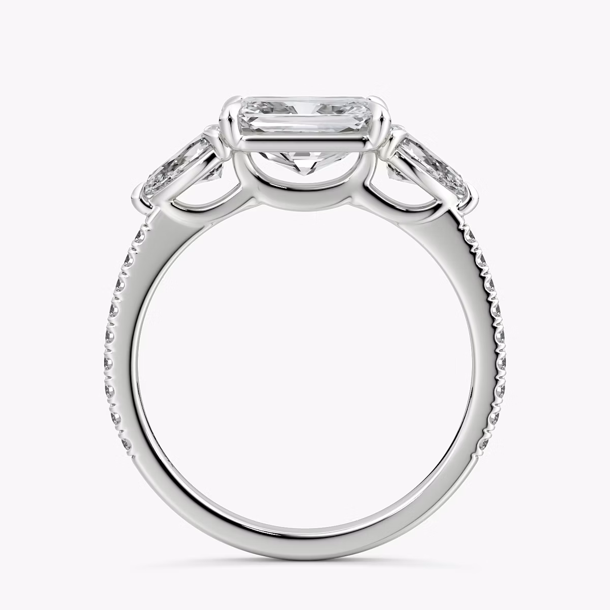 The Three Stone | Radiant | Platinum | bandAccent: Pavé | diamondOrientation: horizontal | sideStoneCarat: 0.25ct | sideStoneShape: Pear | caratWeight: other