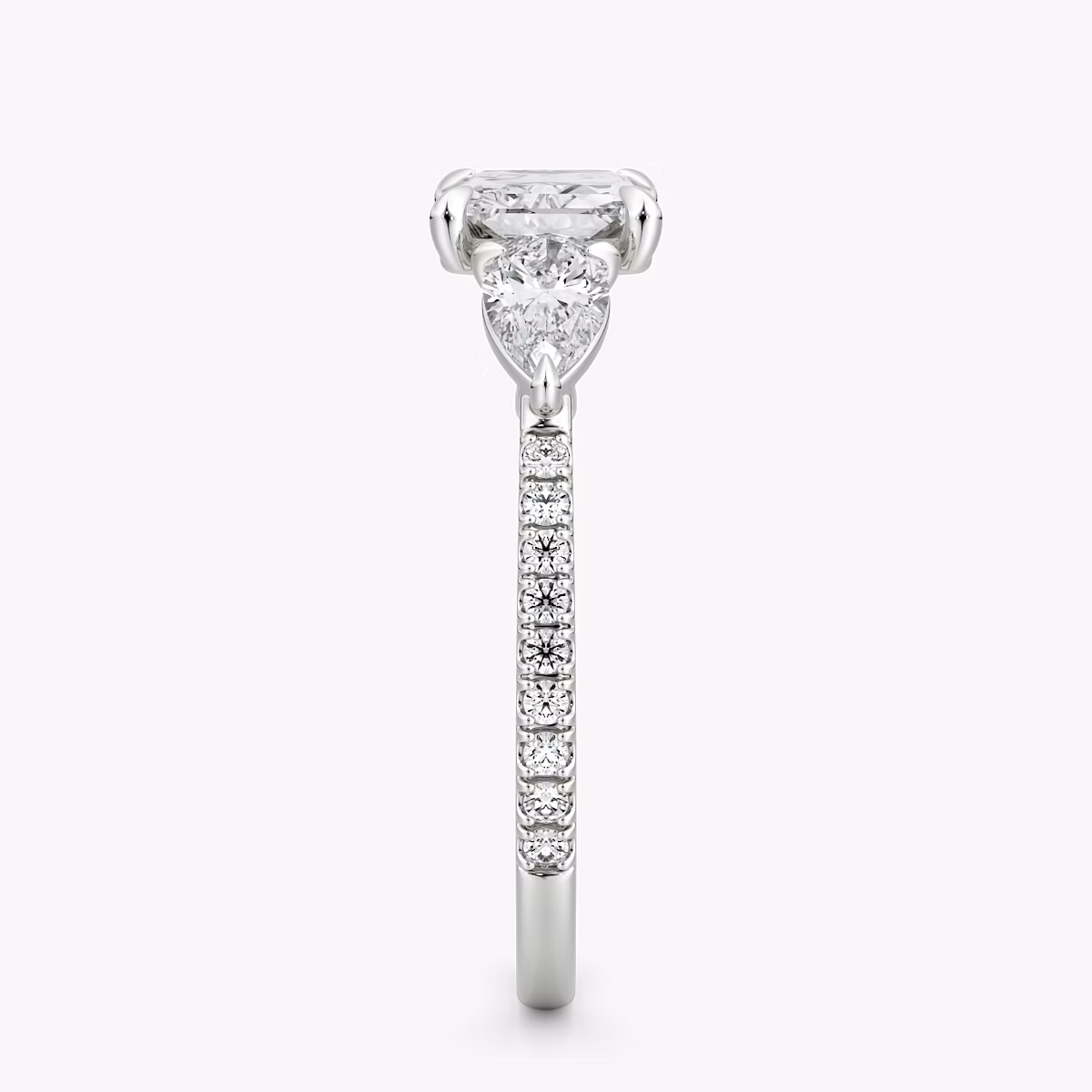 The Three Stone | Radiant | Platinum | bandAccent: Pavé | diamondOrientation: horizontal | sideStoneCarat: 0.25ct | sideStoneShape: Pear | caratWeight: other