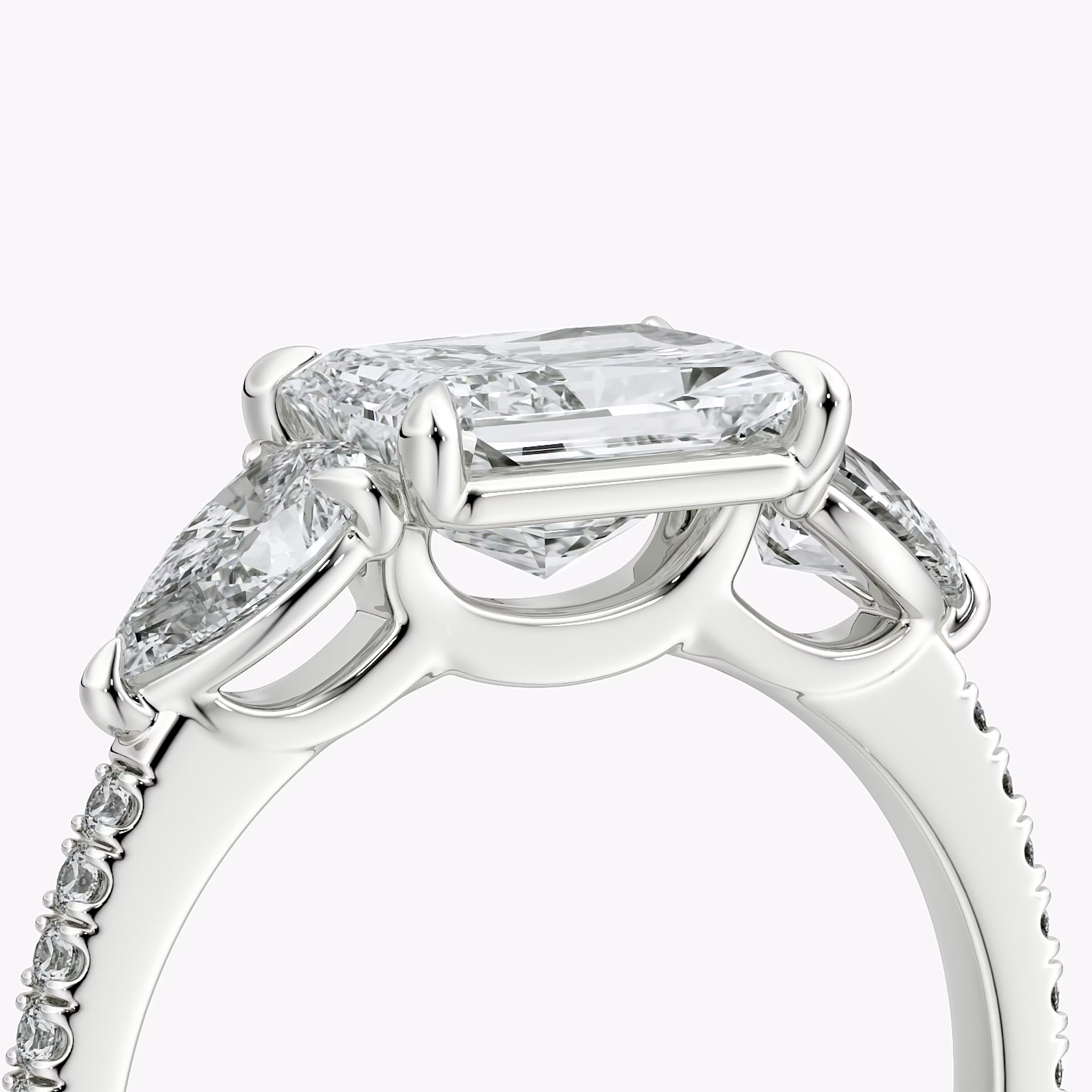 The Three Stone | Radiant | 18k | White Gold | bandAccent: Pavé | diamondOrientation: horizontal | sideStoneCarat: 0.25ct | sideStoneShape: Pear | caratWeight: other