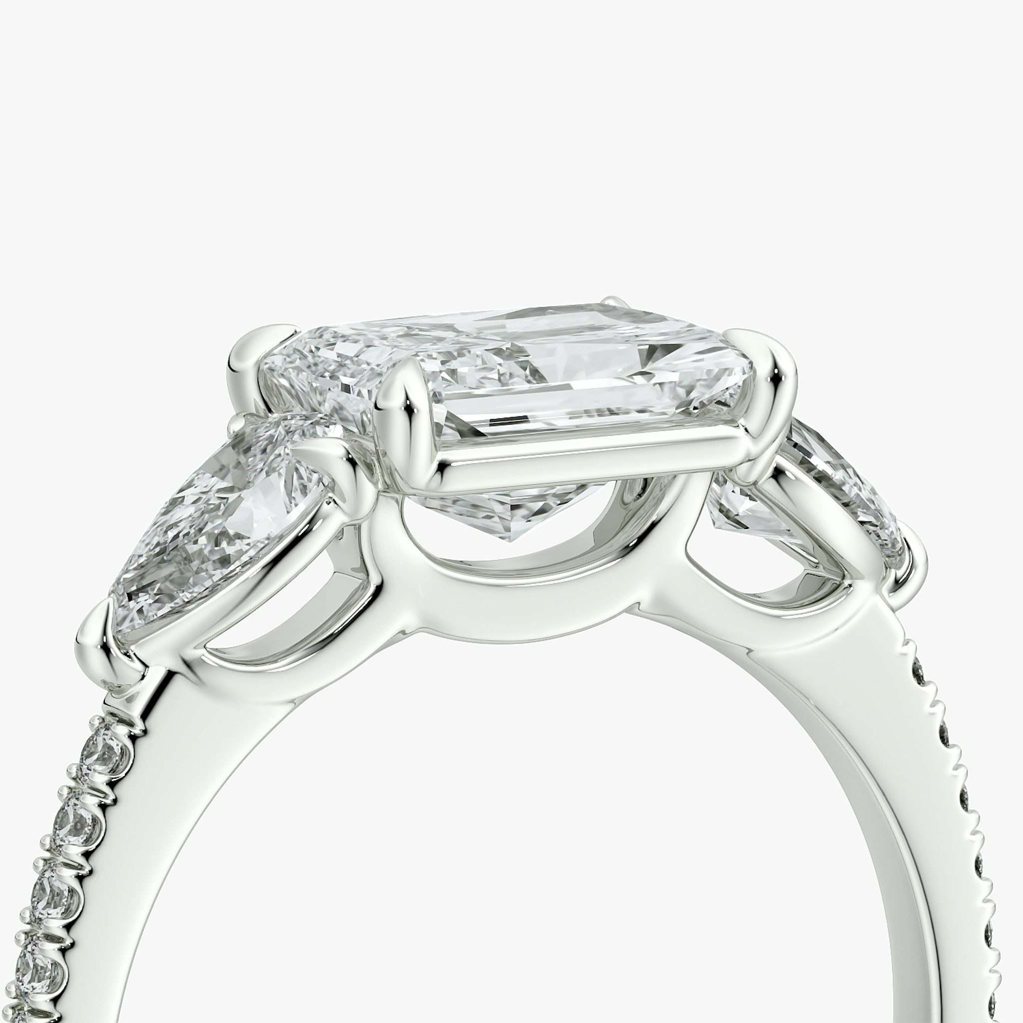 The Three Stone | Radiant | 18k | White Gold | bandAccent: Pavé | diamondOrientation: horizontal | sideStoneCarat: 0.25ct | sideStoneShape: Pear | caratWeight: other