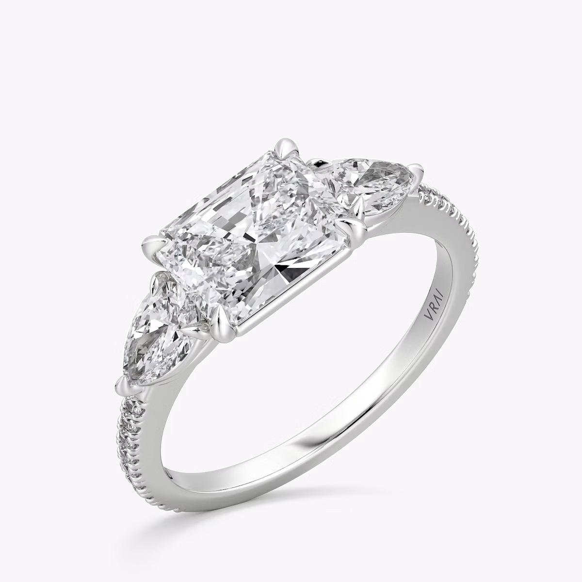 The Three Stone | Radiant | Platinum | bandAccent: Pavé | diamondOrientation: horizontal | sideStoneCarat: 0.25ct | sideStoneShape: Pear | caratWeight: other