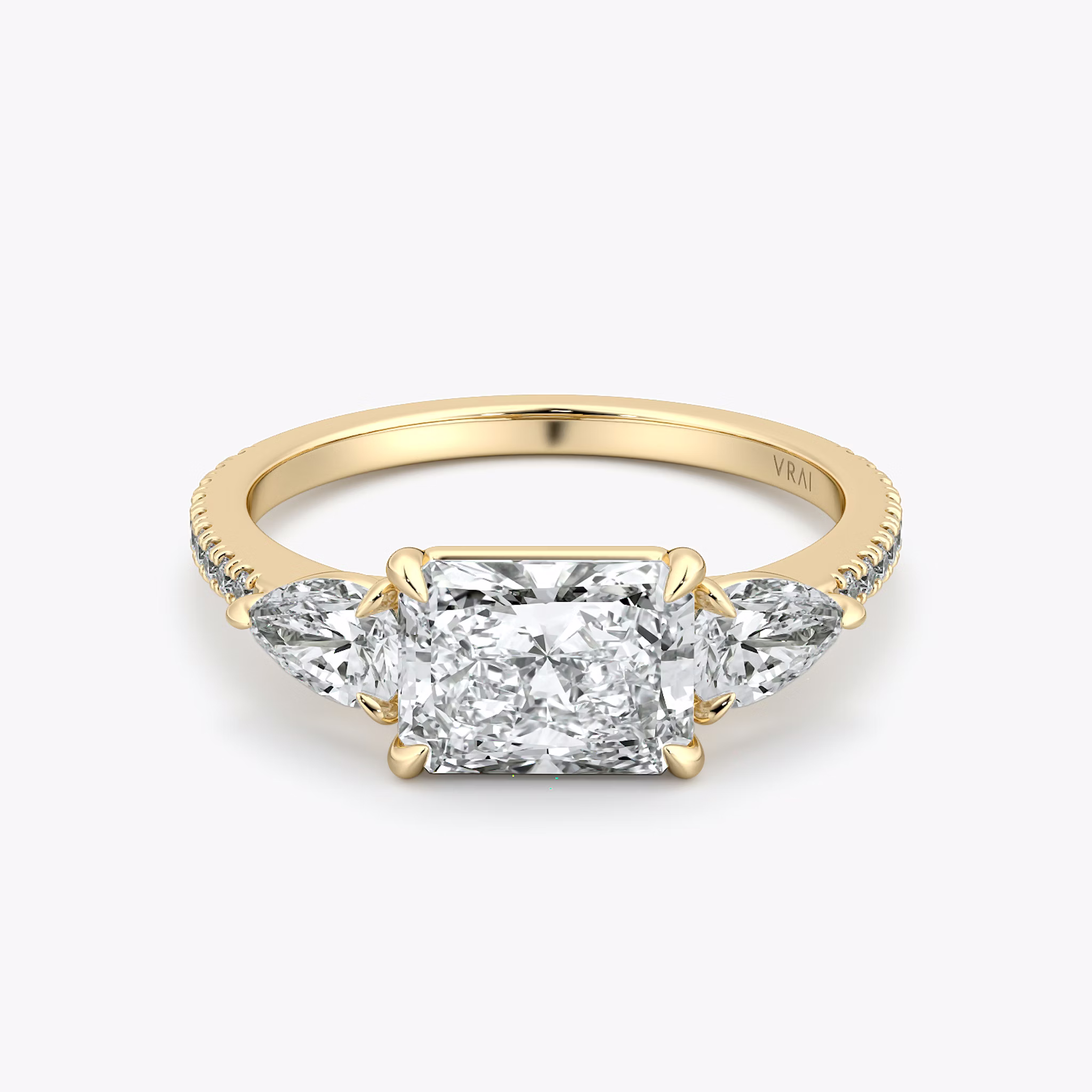 The Three Stone | Radiant | 18k | Yellow Gold | bandAccent: Pavé | diamondOrientation: horizontal | sideStoneCarat: 0.25ct | sideStoneShape: Pear | caratWeight: other