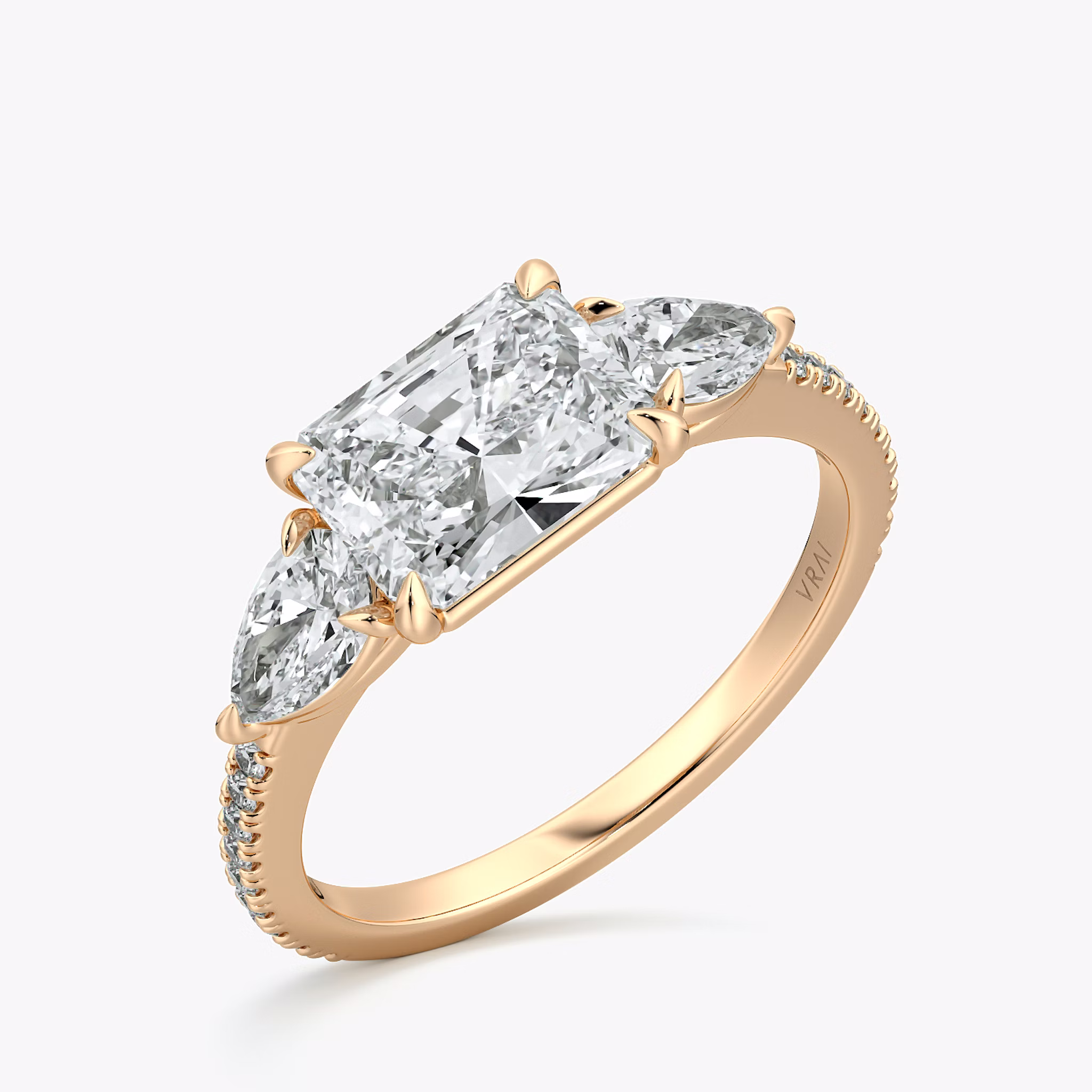 The Three Stone | Radiant | 14k | Rose Gold | bandAccent: Pavé | diamondOrientation: horizontal | sideStoneCarat: 0.25ct | sideStoneShape: Pear | caratWeight: other