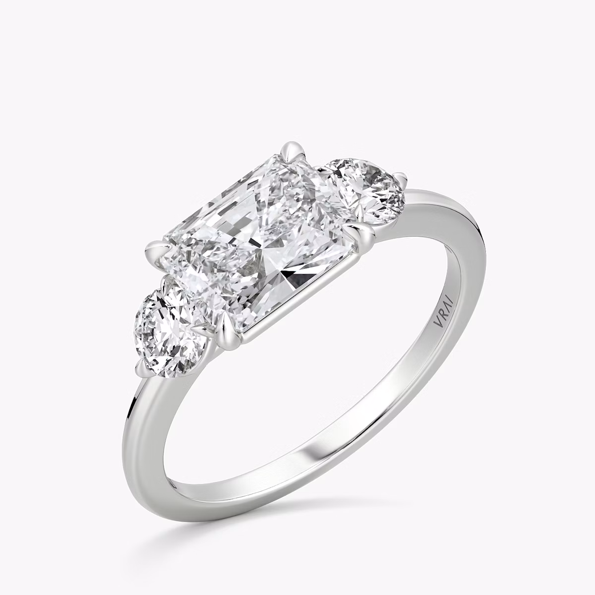 The Three Stone | Radiant | 18k | White Gold | bandAccent: Plain | diamondOrientation: horizontal | sideStoneCarat: 0.25ct | sideStoneShape: Round Brilliant | caratWeight: other