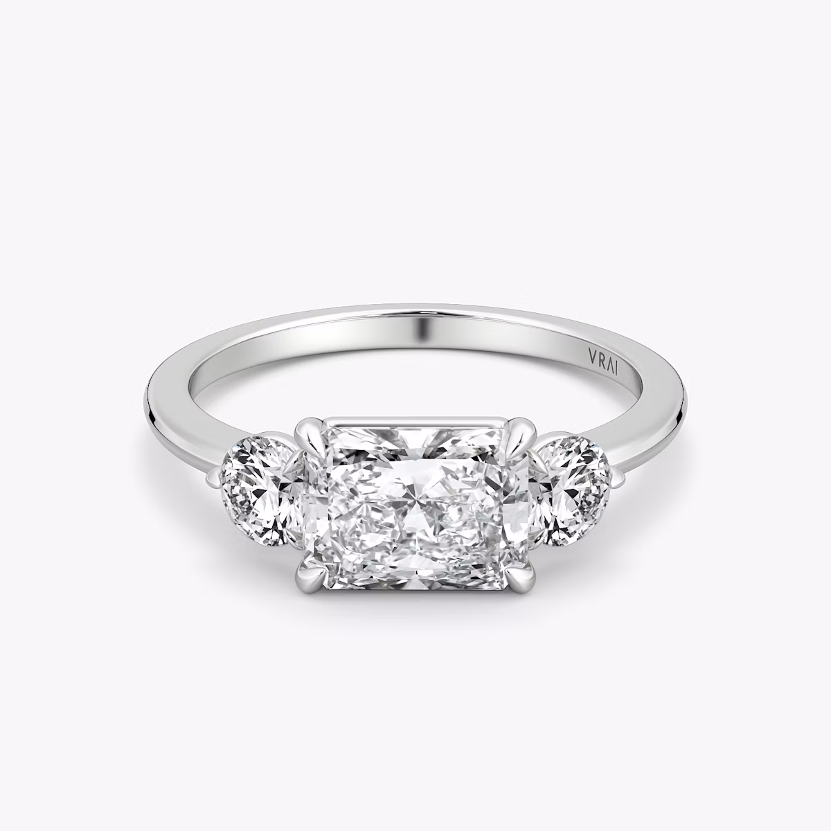 The Three Stone | Radiant | 18k | White Gold | bandAccent: Plain | diamondOrientation: horizontal | sideStoneCarat: 0.25ct | sideStoneShape: Round Brilliant | caratWeight: other