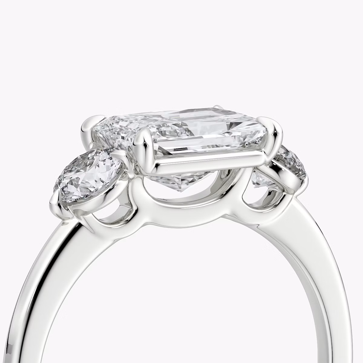 The Three Stone | Radiant | 18k | White Gold | bandAccent: Plain | diamondOrientation: horizontal | sideStoneCarat: 0.25ct | sideStoneShape: Round Brilliant | caratWeight: other