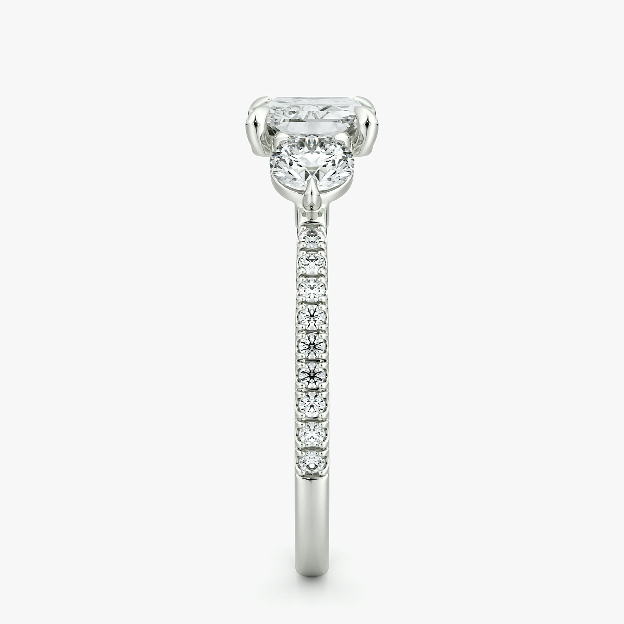 The Three Stone | Radiant | 18k | White Gold | bandAccent: Pavé | diamondOrientation: horizontal | sideStoneCarat: 0.25ct | sideStoneShape: Round Brilliant | caratWeight: other