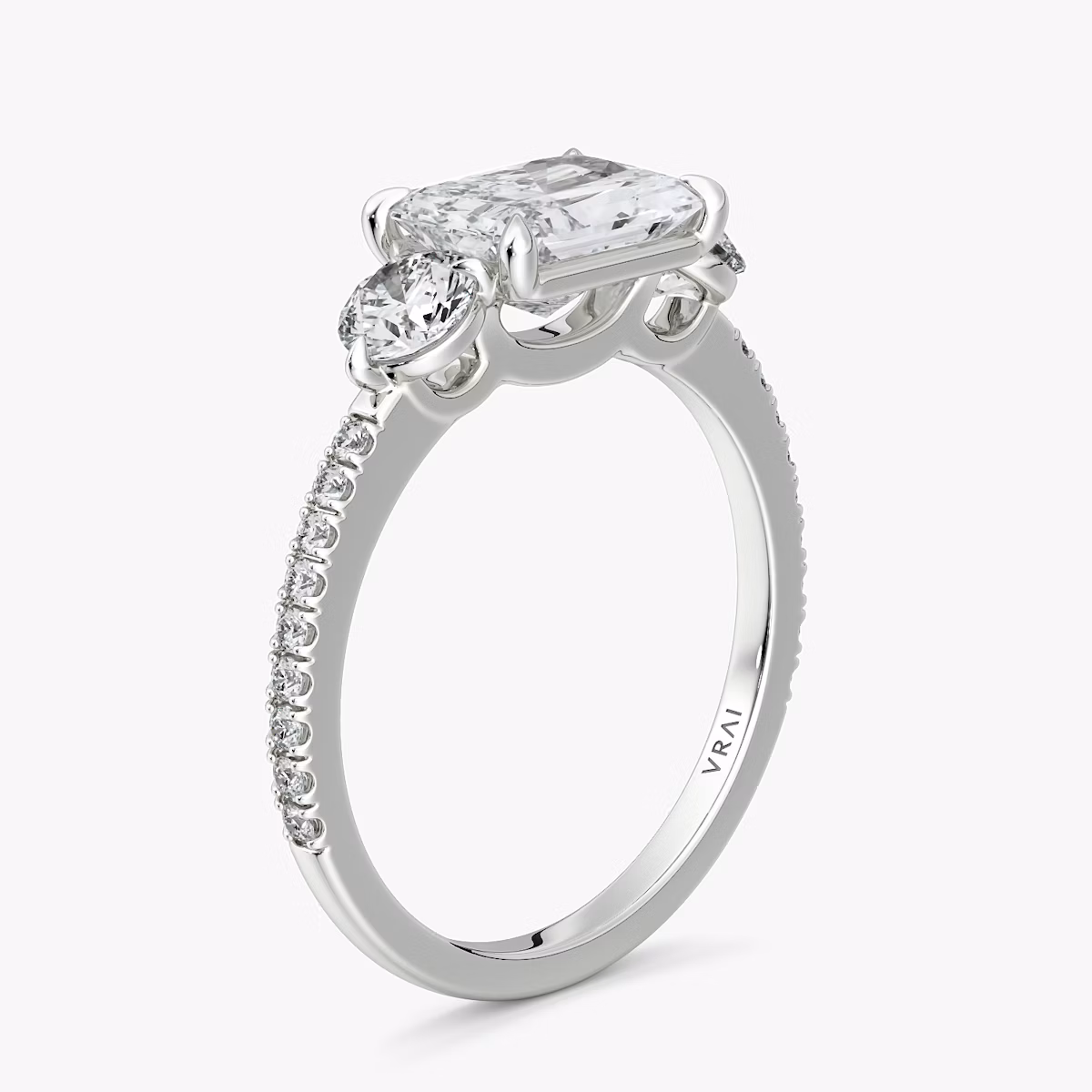 The Three Stone | Radiant | 18k | White Gold | bandAccent: Pavé | diamondOrientation: horizontal | sideStoneCarat: 0.25ct | sideStoneShape: Round Brilliant | caratWeight: other