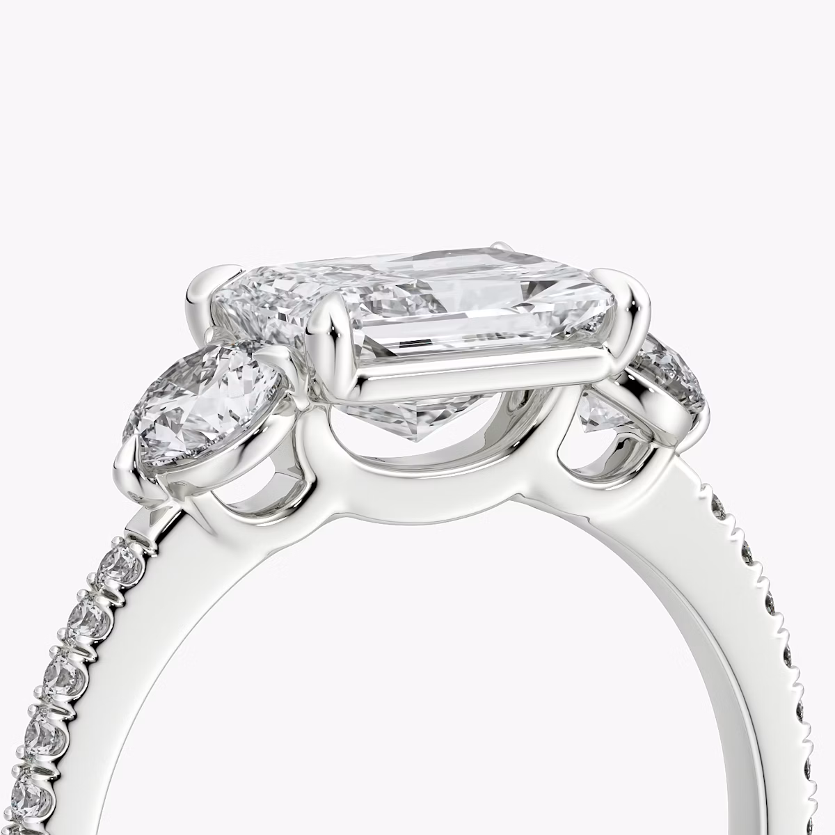 The Three Stone | Radiant | 18k | White Gold | bandAccent: Pavé | diamondOrientation: horizontal | sideStoneCarat: 0.25ct | sideStoneShape: Round Brilliant | caratWeight: other