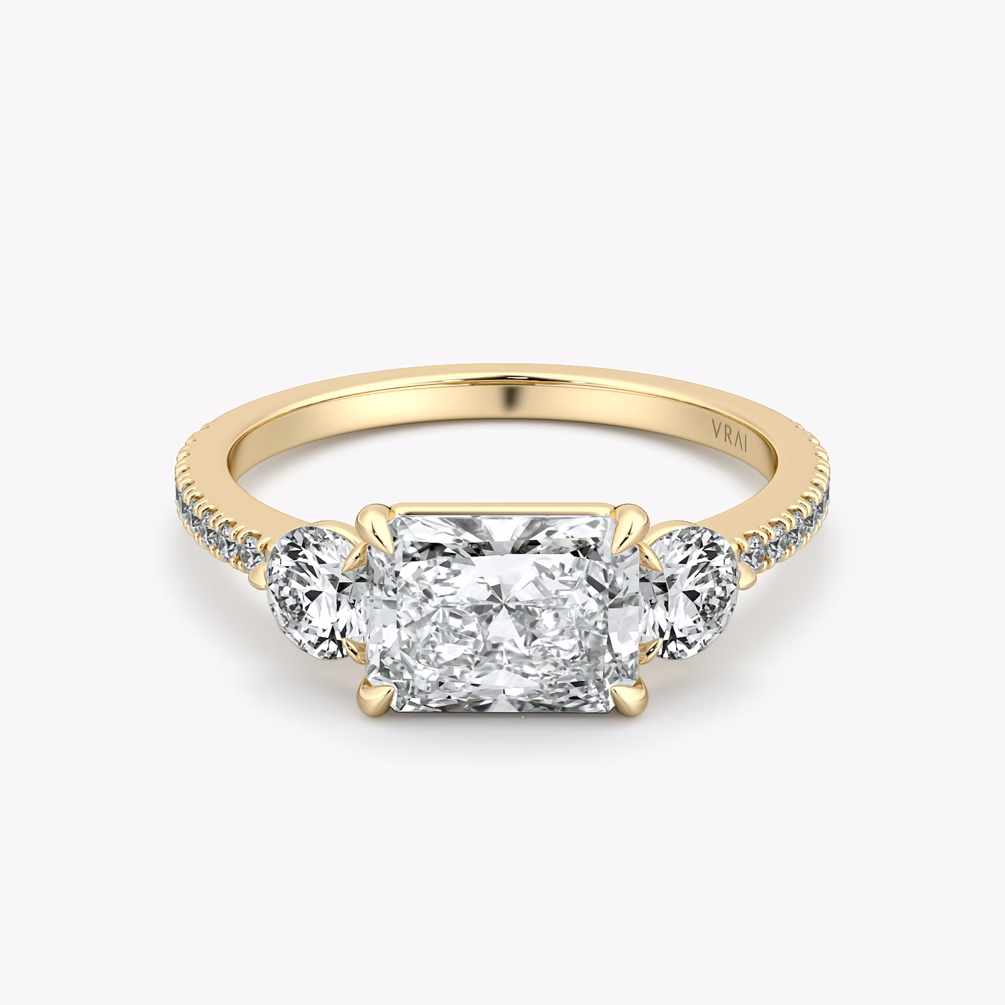 The Three Stone | Radiant | 18k | Yellow Gold | bandAccent: Pavé | diamondOrientation: horizontal | sideStoneCarat: 0.25ct | sideStoneShape: Round Brilliant | caratWeight: other
