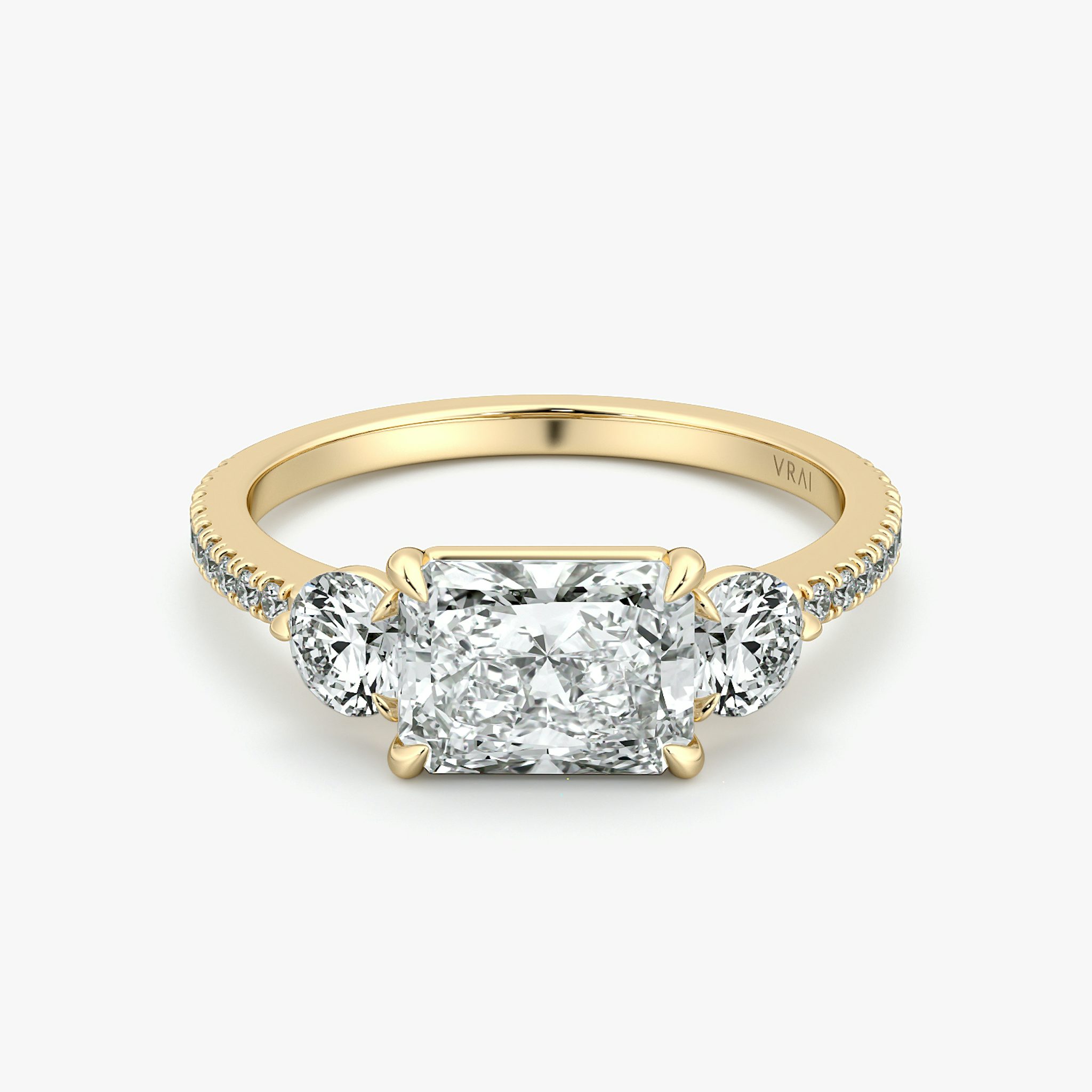 The Three Stone | Radiant | 18k | Yellow Gold | bandAccent: Pavé | diamondOrientation: horizontal | sideStoneCarat: 0.25ct | sideStoneShape: Round Brilliant | caratWeight: other