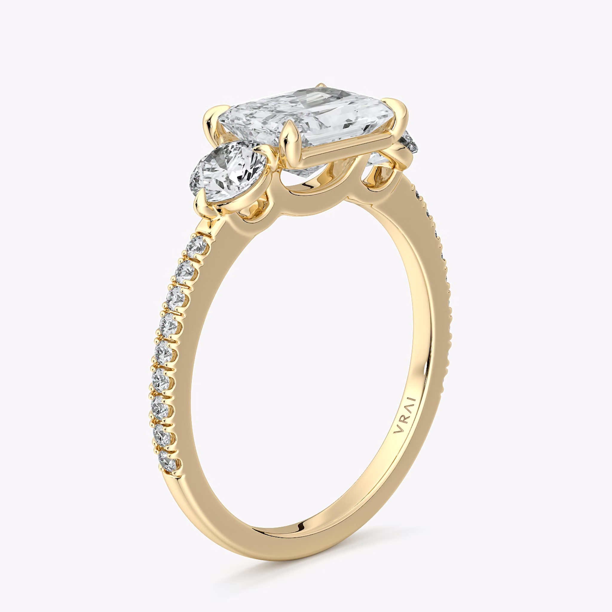 The Three Stone | Radiant | 18k | Yellow Gold | bandAccent: Pavé | diamondOrientation: horizontal | sideStoneCarat: 0.25ct | sideStoneShape: Round Brilliant | caratWeight: other