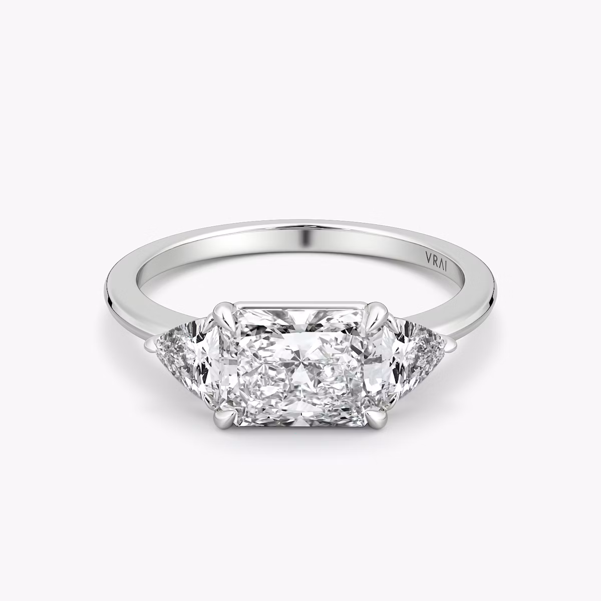 The Three Stone | Radiant | 18k | White Gold | bandAccent: Plain | diamondOrientation: horizontal | sideStoneCarat: 0.25ct | sideStoneShape: Trillion | caratWeight: other