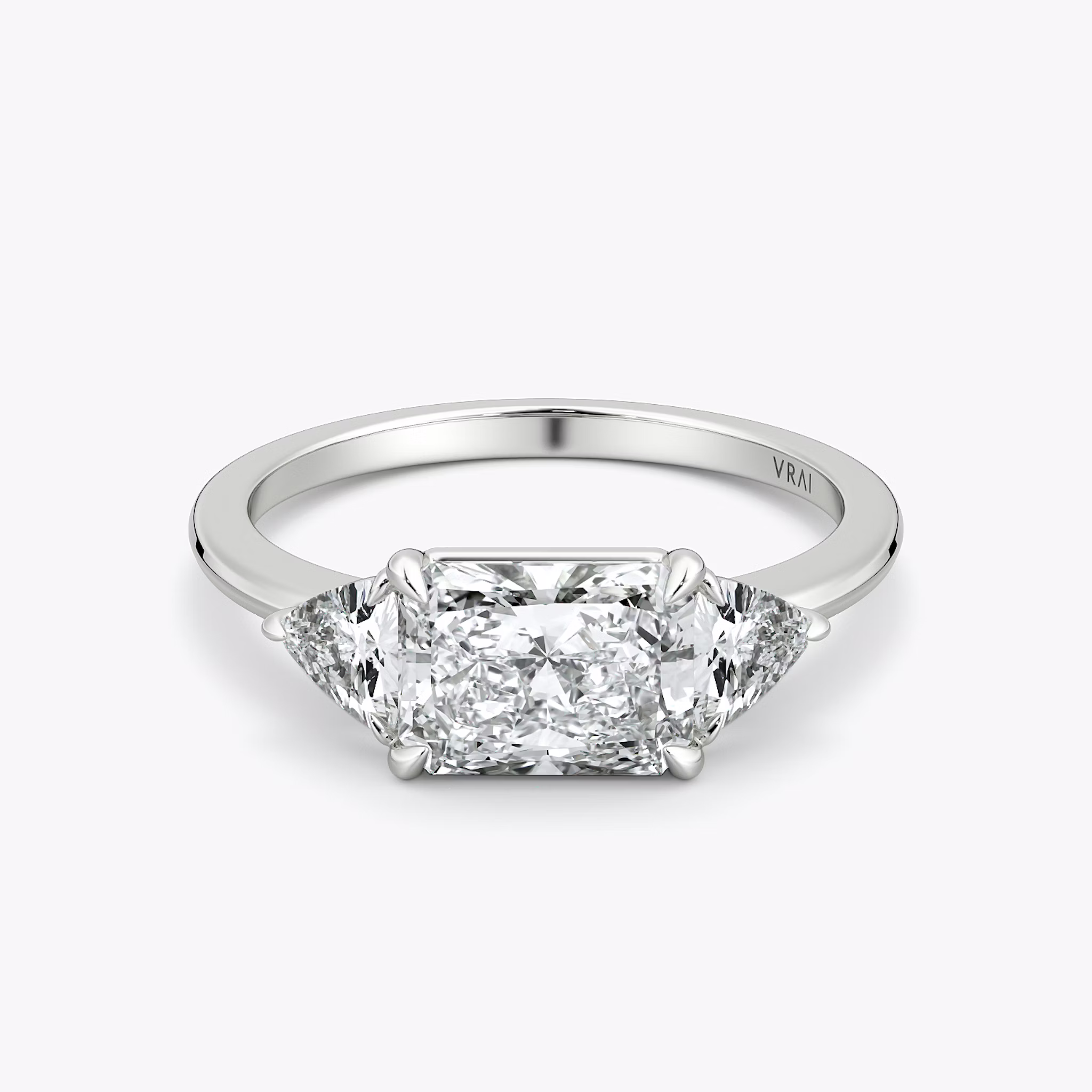 The Three Stone | Radiant | Platinum | bandAccent: Plain | diamondOrientation: horizontal | sideStoneCarat: 0.25ct | sideStoneShape: Trillion | caratWeight: other