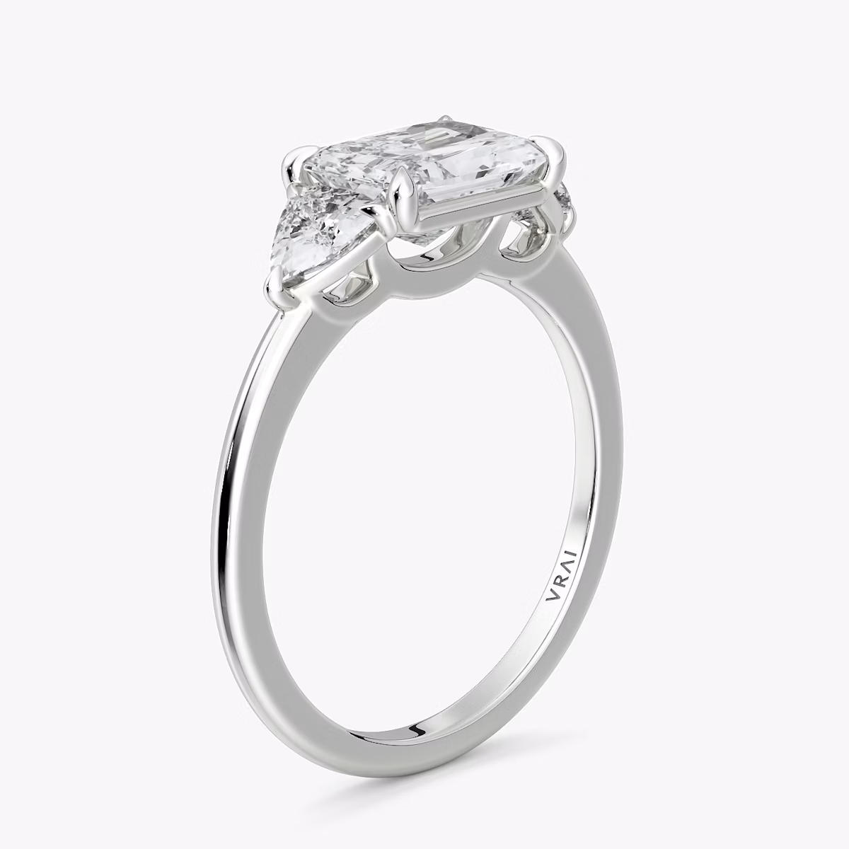 The Three Stone | Radiant | 18k | White Gold | bandAccent: Plain | diamondOrientation: horizontal | sideStoneCarat: 0.25ct | sideStoneShape: Trillion | caratWeight: other