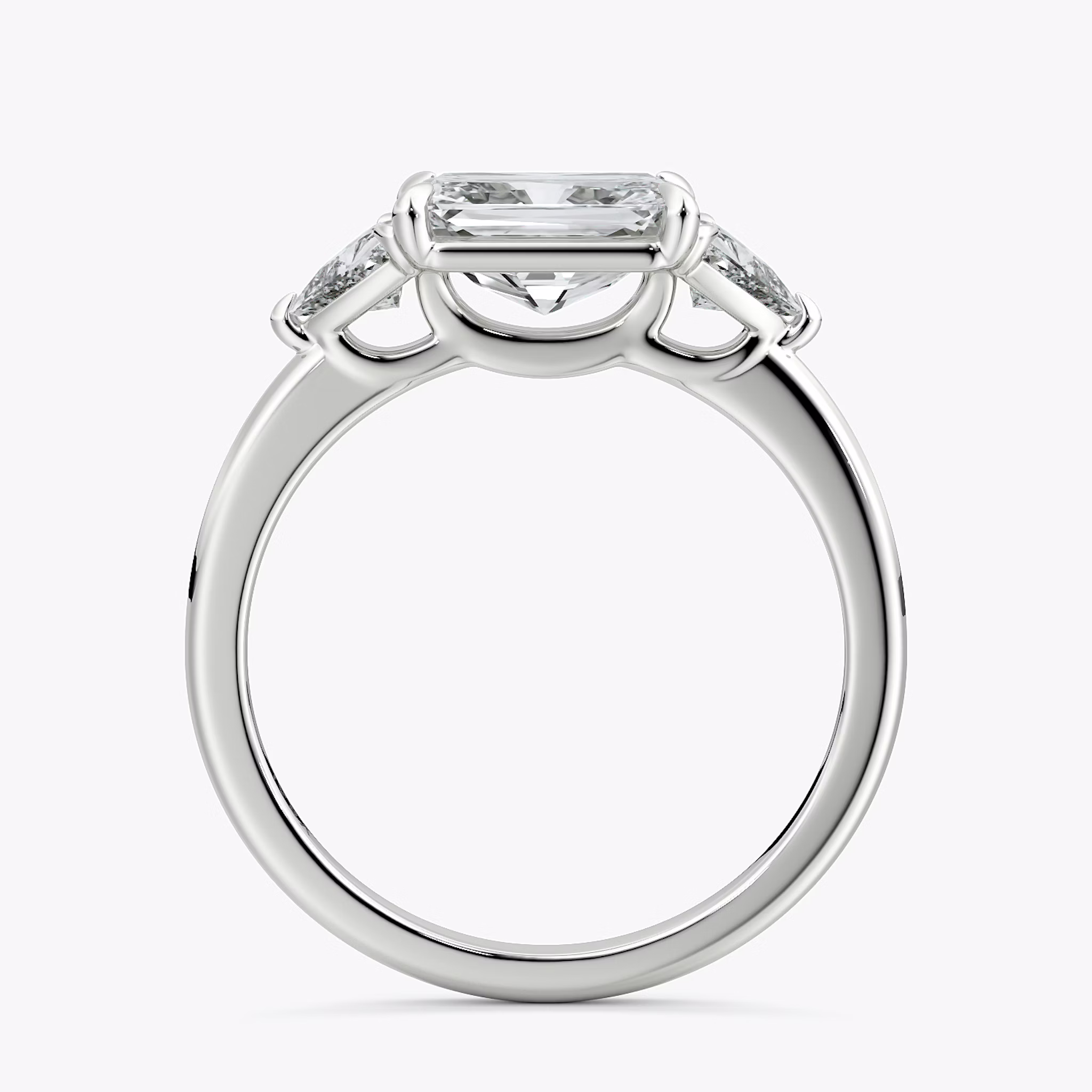 The Three Stone | Radiant | Platinum | bandAccent: Plain | diamondOrientation: horizontal | sideStoneCarat: 0.25ct | sideStoneShape: Trillion | caratWeight: other