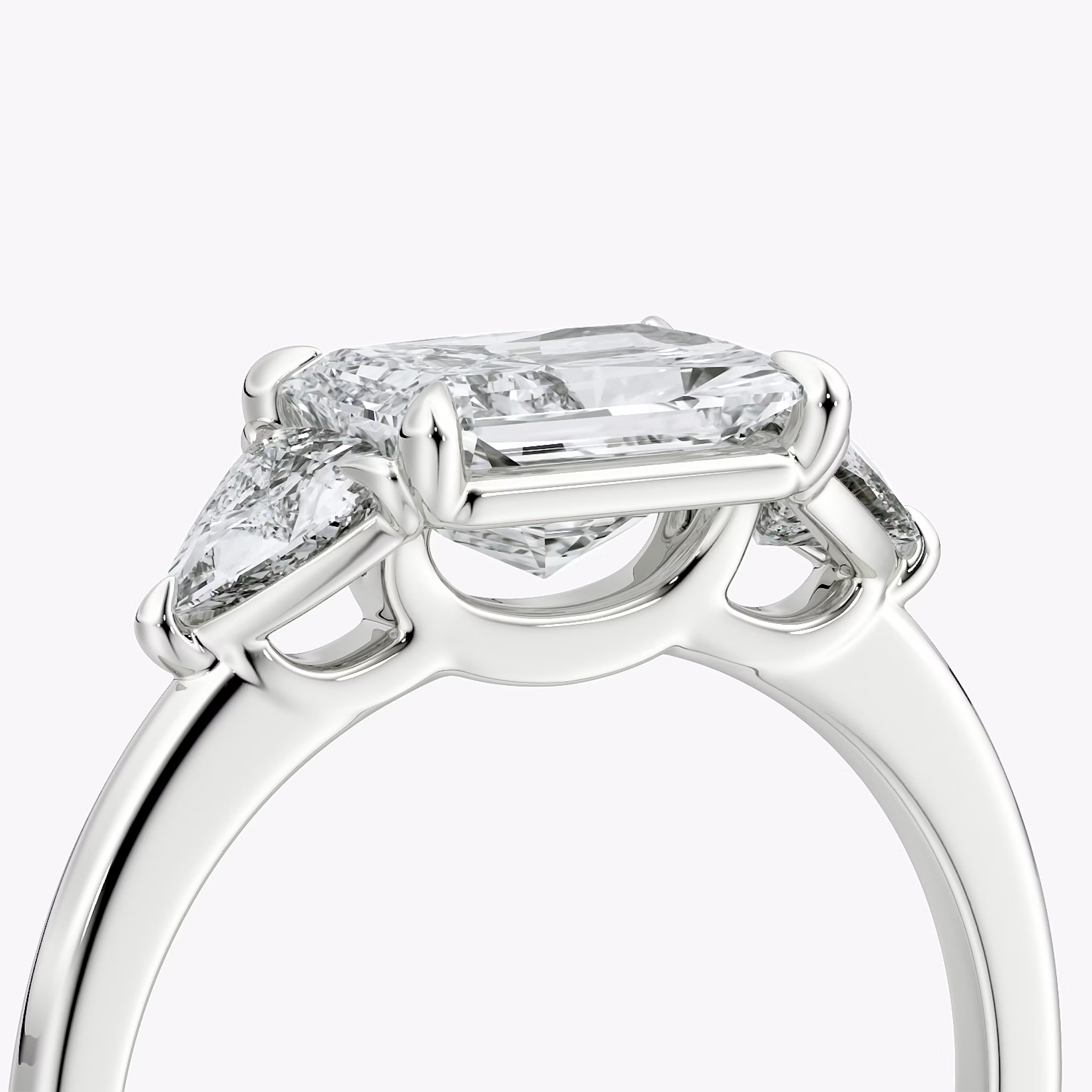 The Three Stone | Radiant | Platinum | bandAccent: Plain | diamondOrientation: horizontal | sideStoneCarat: 0.25ct | sideStoneShape: Trillion | caratWeight: other