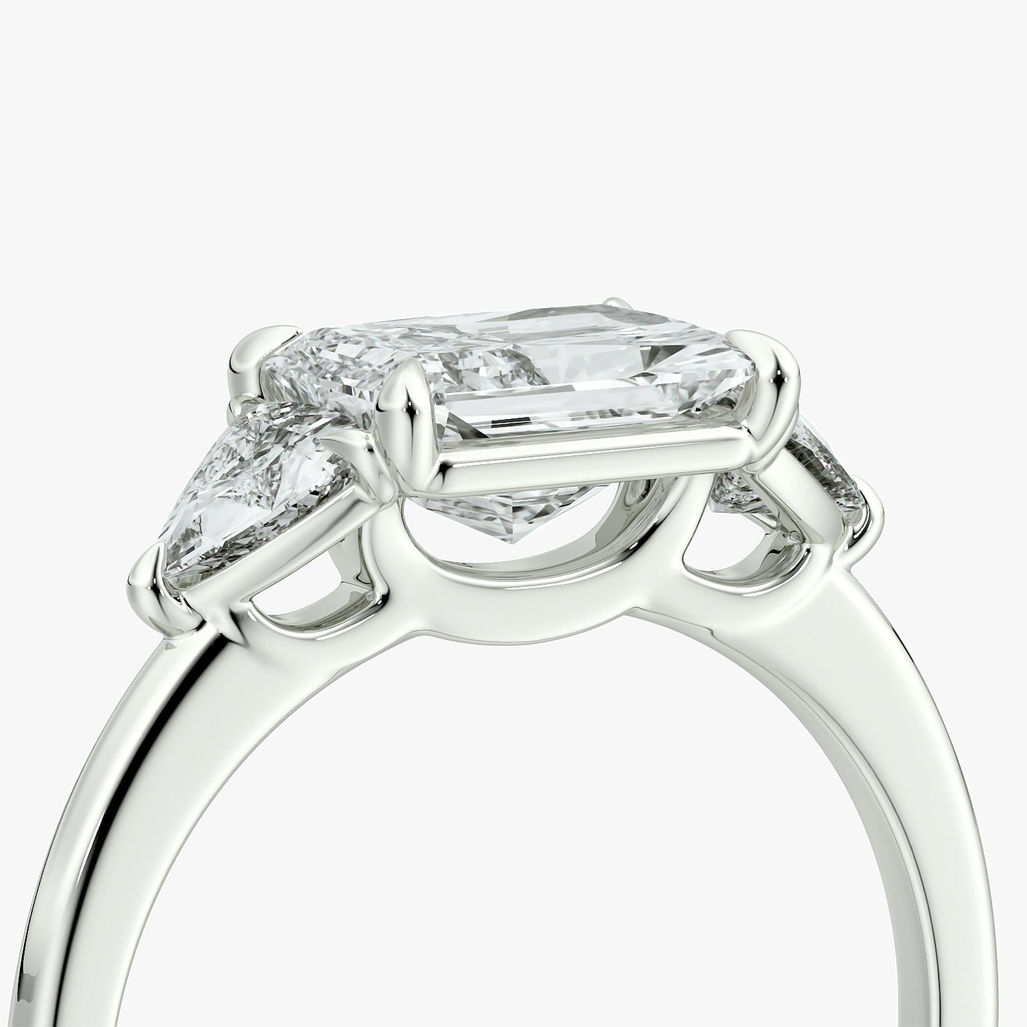 The Three Stone | Radiant | Platinum | bandAccent: Plain | diamondOrientation: horizontal | sideStoneCarat: 0.25ct | sideStoneShape: Trillion | caratWeight: other