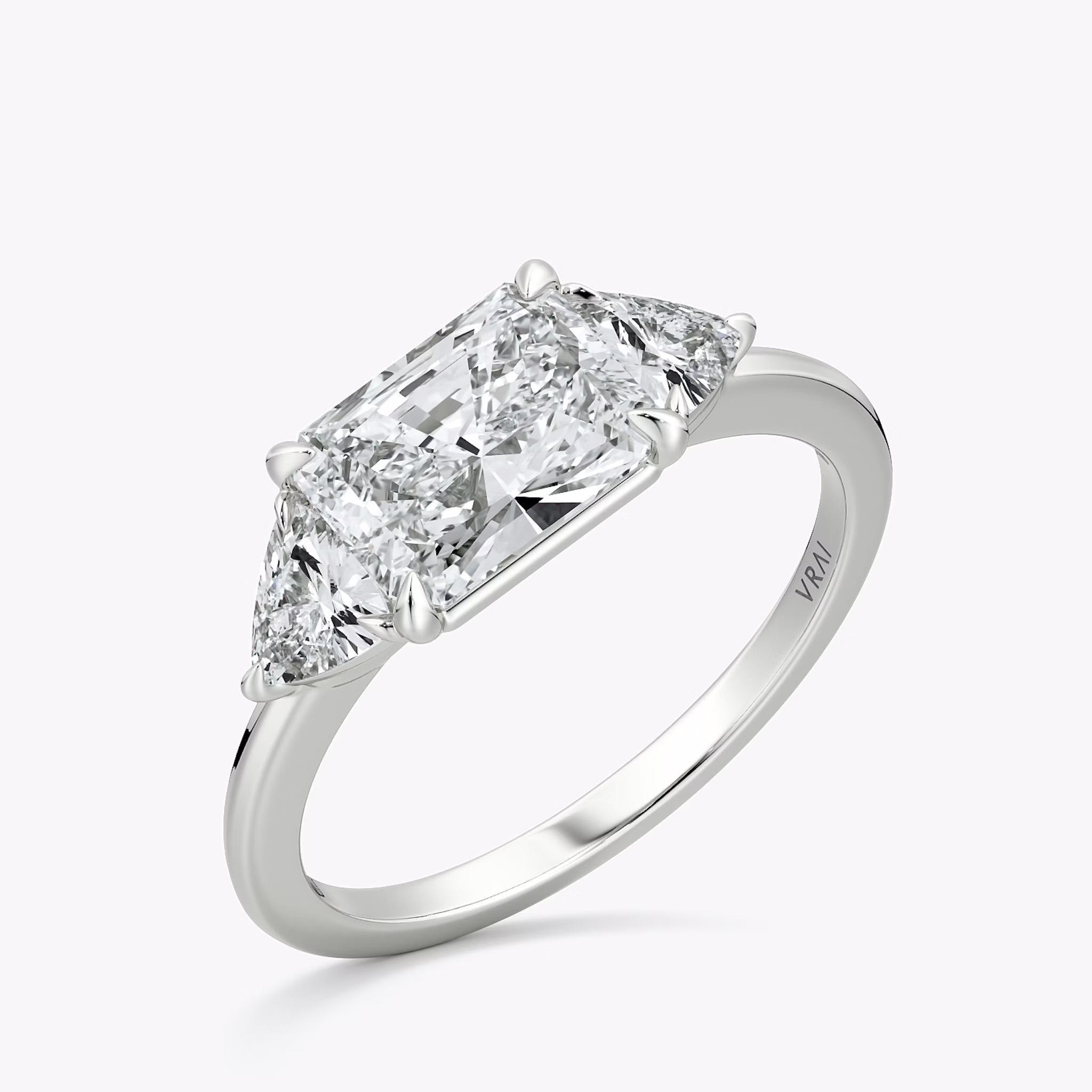 The Three Stone | Radiant | Platinum | bandAccent: Plain | diamondOrientation: horizontal | sideStoneCarat: 0.25ct | sideStoneShape: Trillion | caratWeight: other