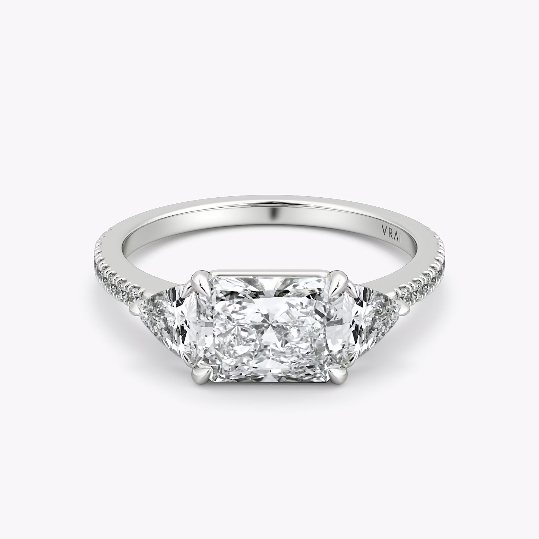 The Three Stone | Radiant | Platinum | bandAccent: Pavé | diamondOrientation: horizontal | sideStoneCarat: 0.25ct | sideStoneShape: Trillion | caratWeight: other