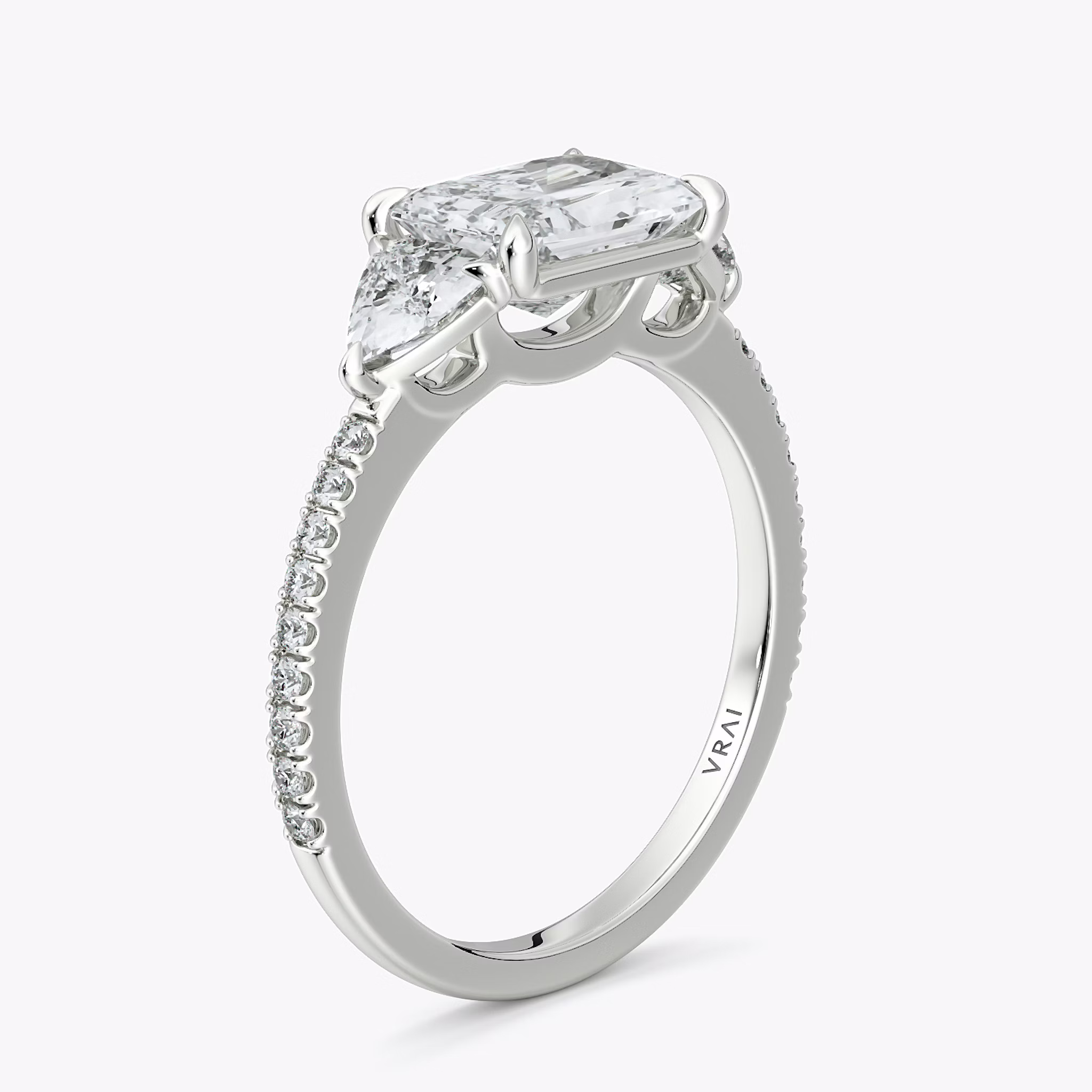 The Three Stone | Radiant | Platinum | bandAccent: Pavé | diamondOrientation: horizontal | sideStoneCarat: 0.25ct | sideStoneShape: Trillion | caratWeight: other