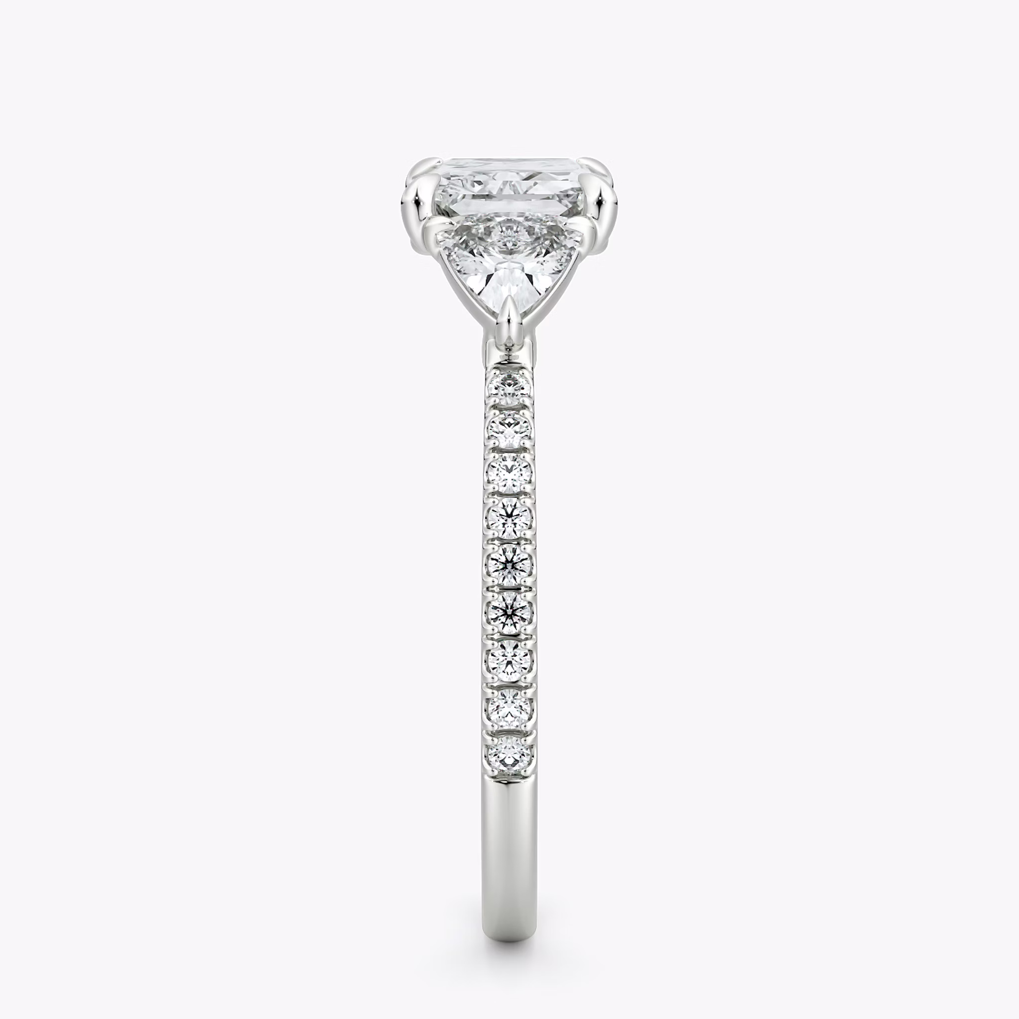 The Three Stone | Radiant | Platinum | bandAccent: Pavé | diamondOrientation: horizontal | sideStoneCarat: 0.25ct | sideStoneShape: Trillion | caratWeight: other