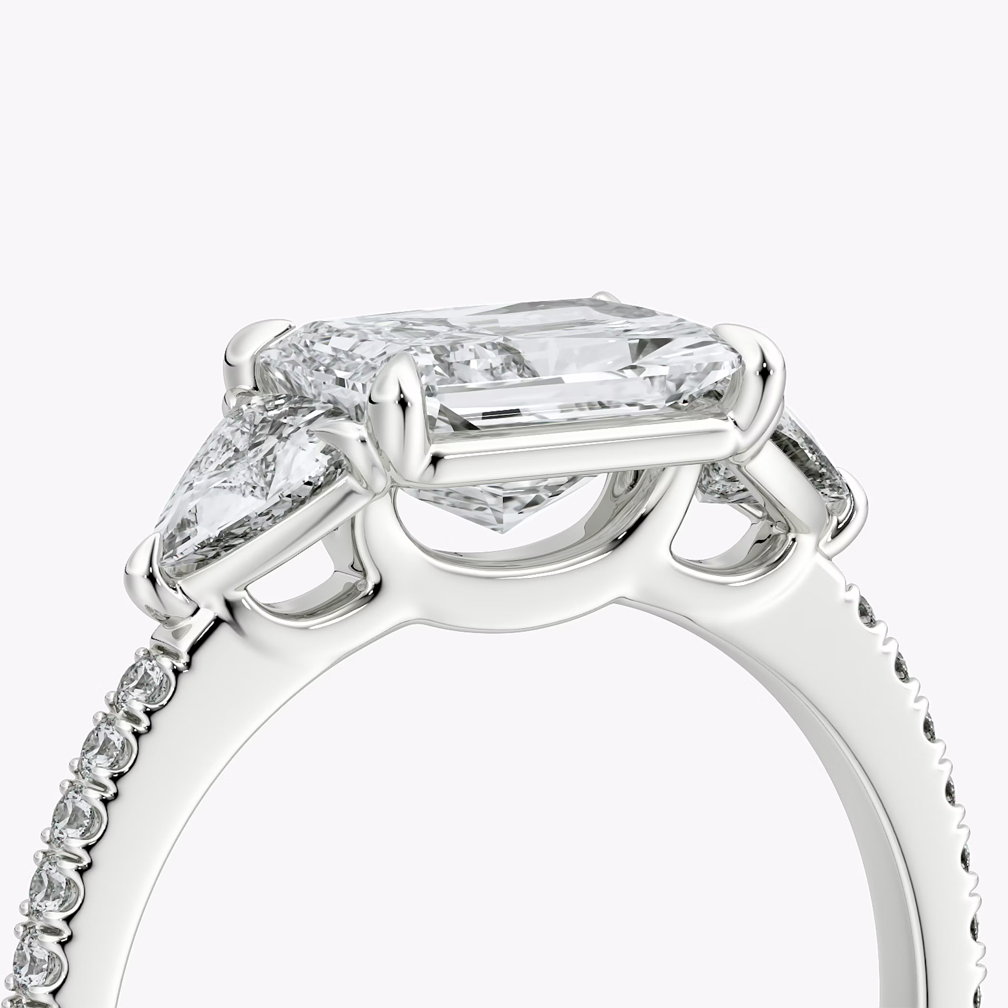 The Three Stone | Radiant | Platinum | bandAccent: Pavé | diamondOrientation: horizontal | sideStoneCarat: 0.25ct | sideStoneShape: Trillion | caratWeight: other