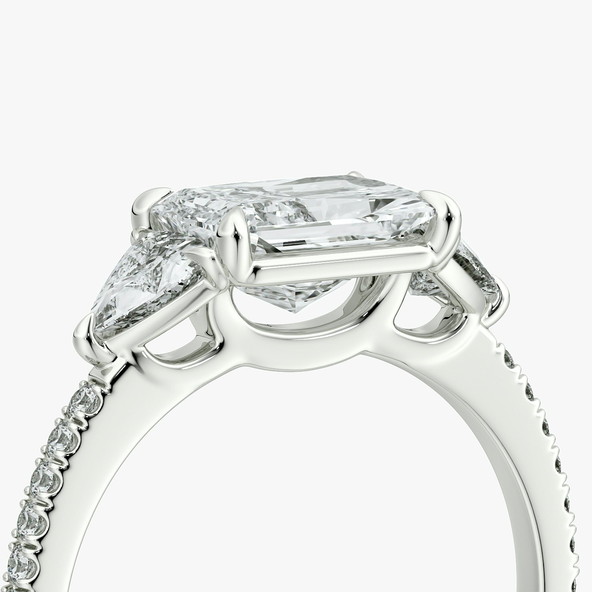 The Three Stone | Radiant | Platinum | bandAccent: Pavé | diamondOrientation: horizontal | sideStoneCarat: 0.25ct | sideStoneShape: Trillion | caratWeight: other