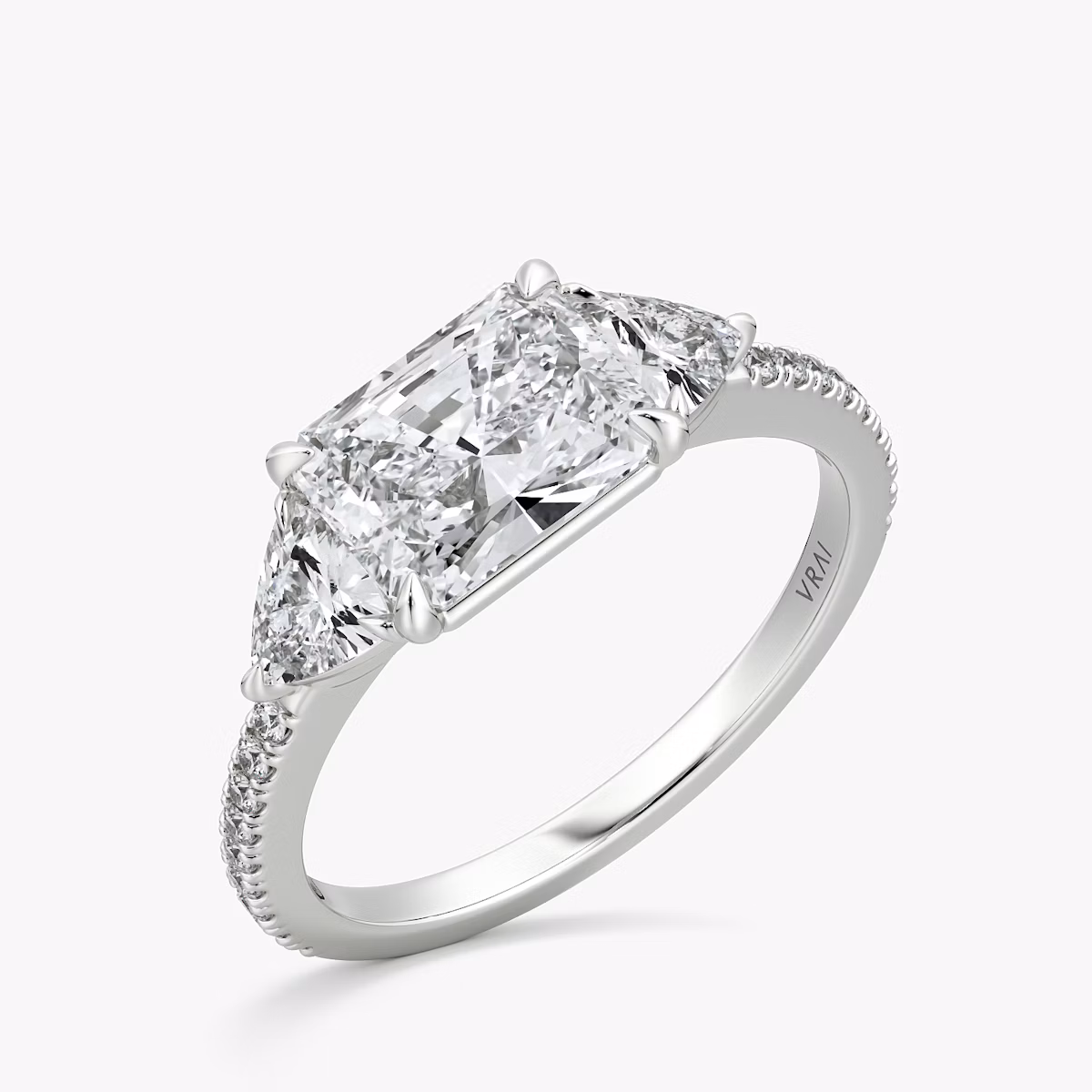 The Three Stone | Radiant | Platinum | bandAccent: Pavé | diamondOrientation: horizontal | sideStoneCarat: 0.25ct | sideStoneShape: Trillion | caratWeight: other