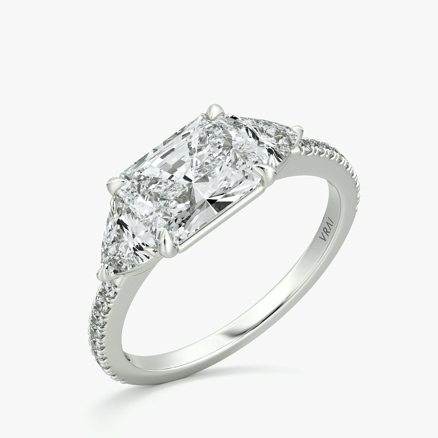 The Three Stone | Radiant | Platinum | bandAccent: Pavé | diamondOrientation: horizontal | sideStoneCarat: 0.25ct | sideStoneShape: Trillion | caratWeight: other