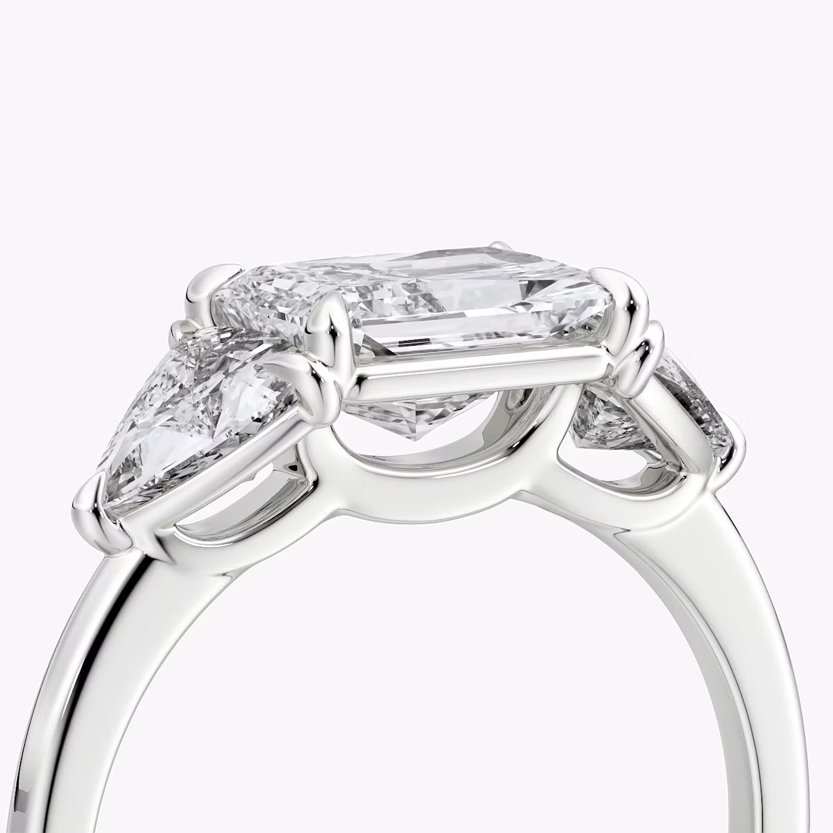 The Three Stone | Radiant | Platinum | bandAccent: Plain | diamondOrientation: horizontal | sideStoneCarat: 0.50ct | sideStoneShape: Trillion | caratWeight: other