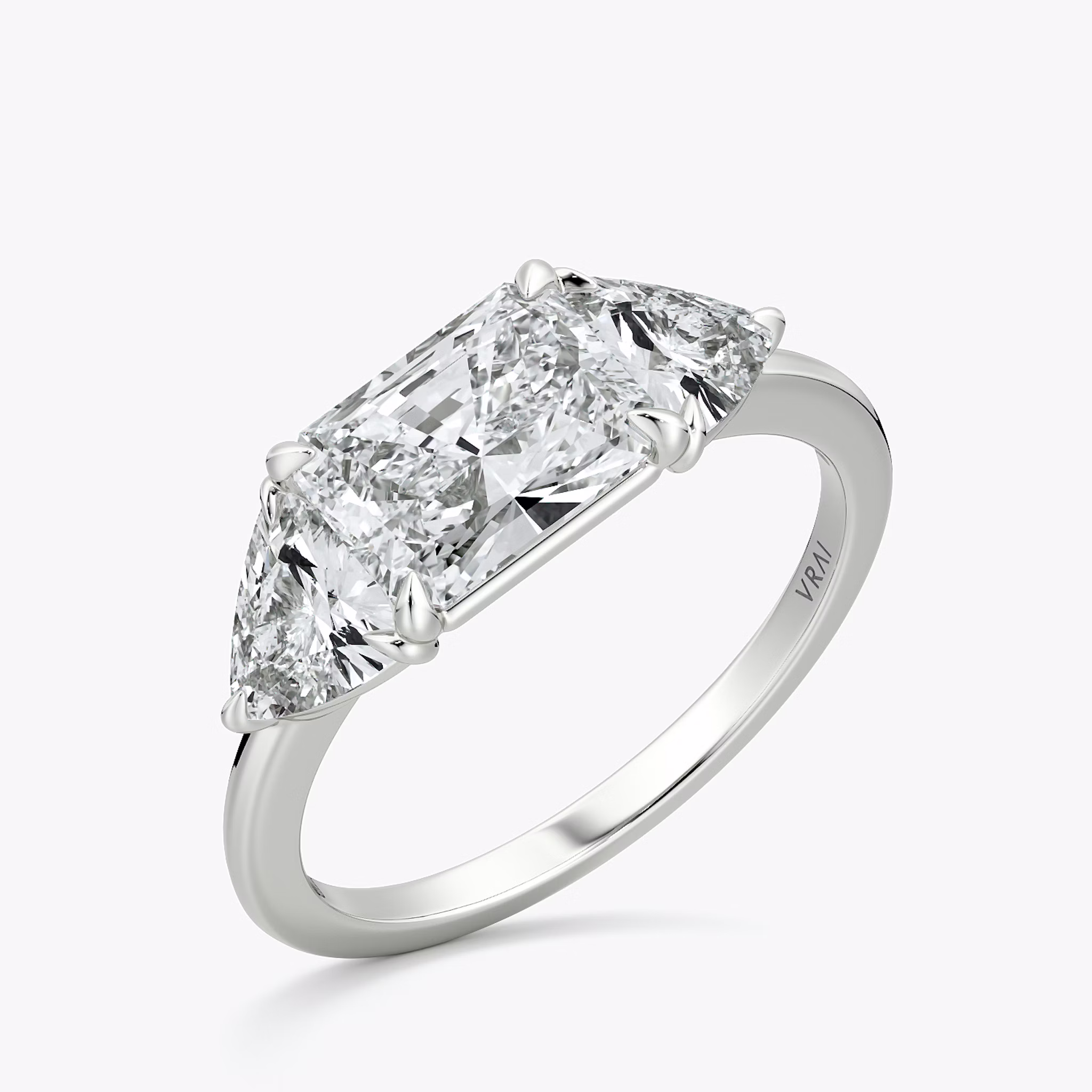 The Three Stone | Radiant | Platinum | bandAccent: Plain | diamondOrientation: horizontal | sideStoneCarat: 0.50ct | sideStoneShape: Trillion | caratWeight: other