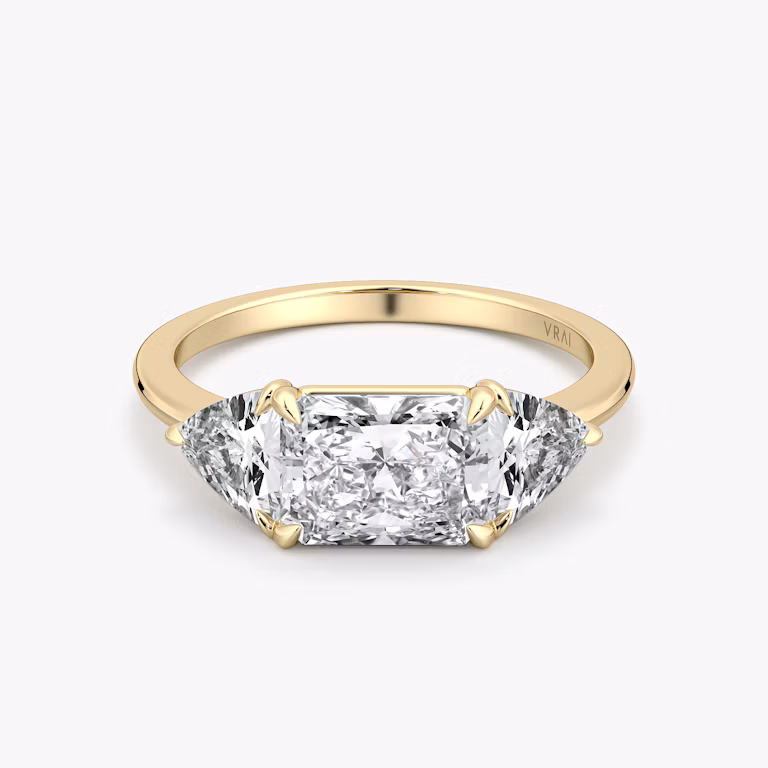 Radiant-cut and trillion-cut three-stone ring with plain yellow gold band, East-West 0.50ct setting.