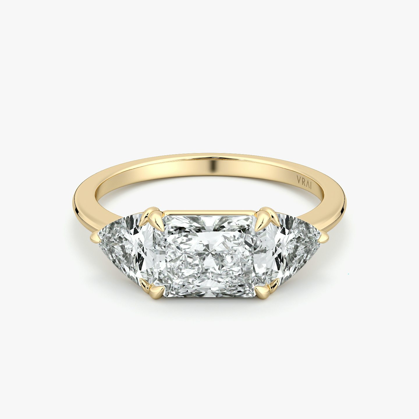 Radiant-cut and trillion-cut three-stone ring with plain yellow gold band, East-West 0.50ct setting.