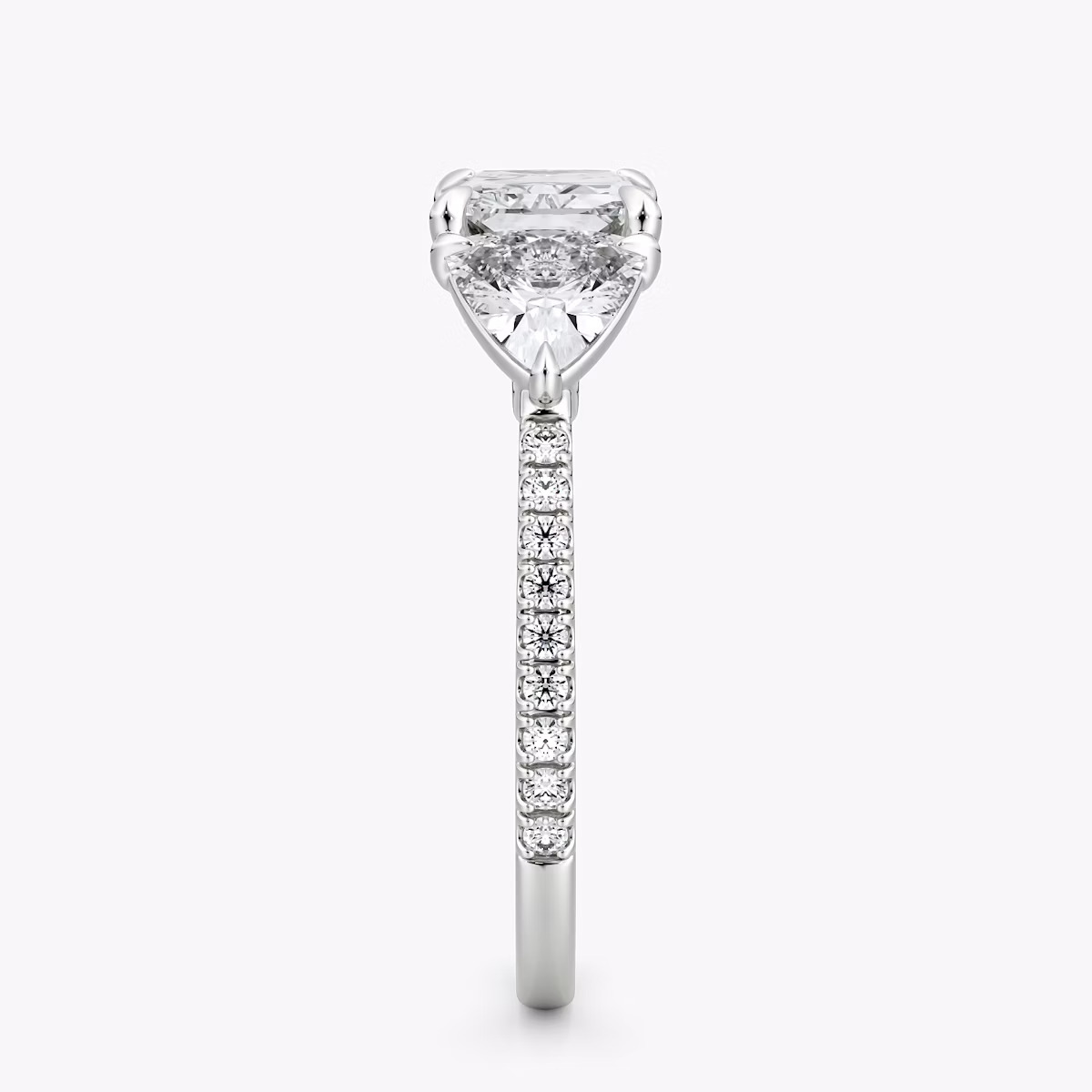 The Three Stone | Radiant | Platinum | bandAccent: Pavé | diamondOrientation: horizontal | sideStoneCarat: 0.50ct | sideStoneShape: Trillion | caratWeight: other