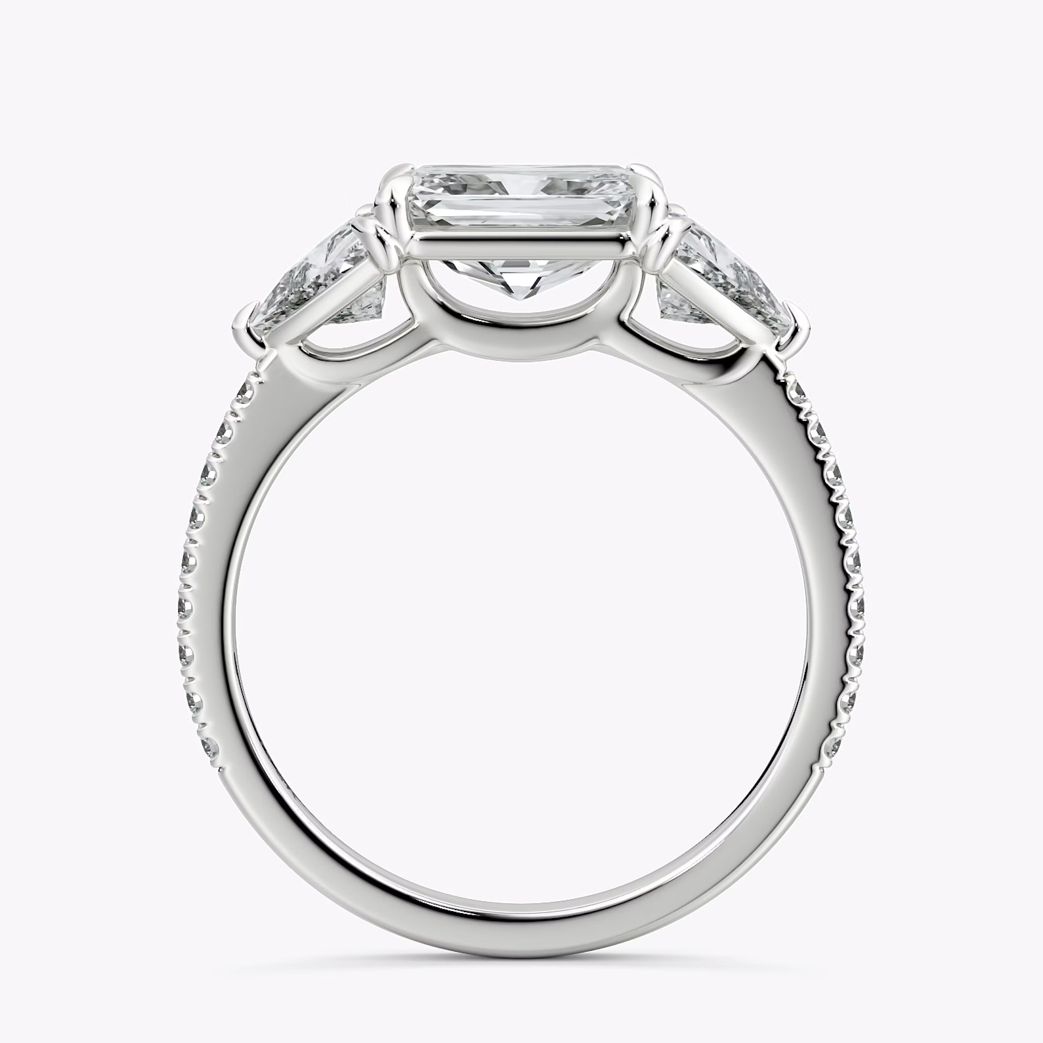 The Three Stone | Radiant | 18k | White Gold | bandAccent: Pavé | diamondOrientation: horizontal | sideStoneCarat: 0.50ct | sideStoneShape: Trillion | caratWeight: other