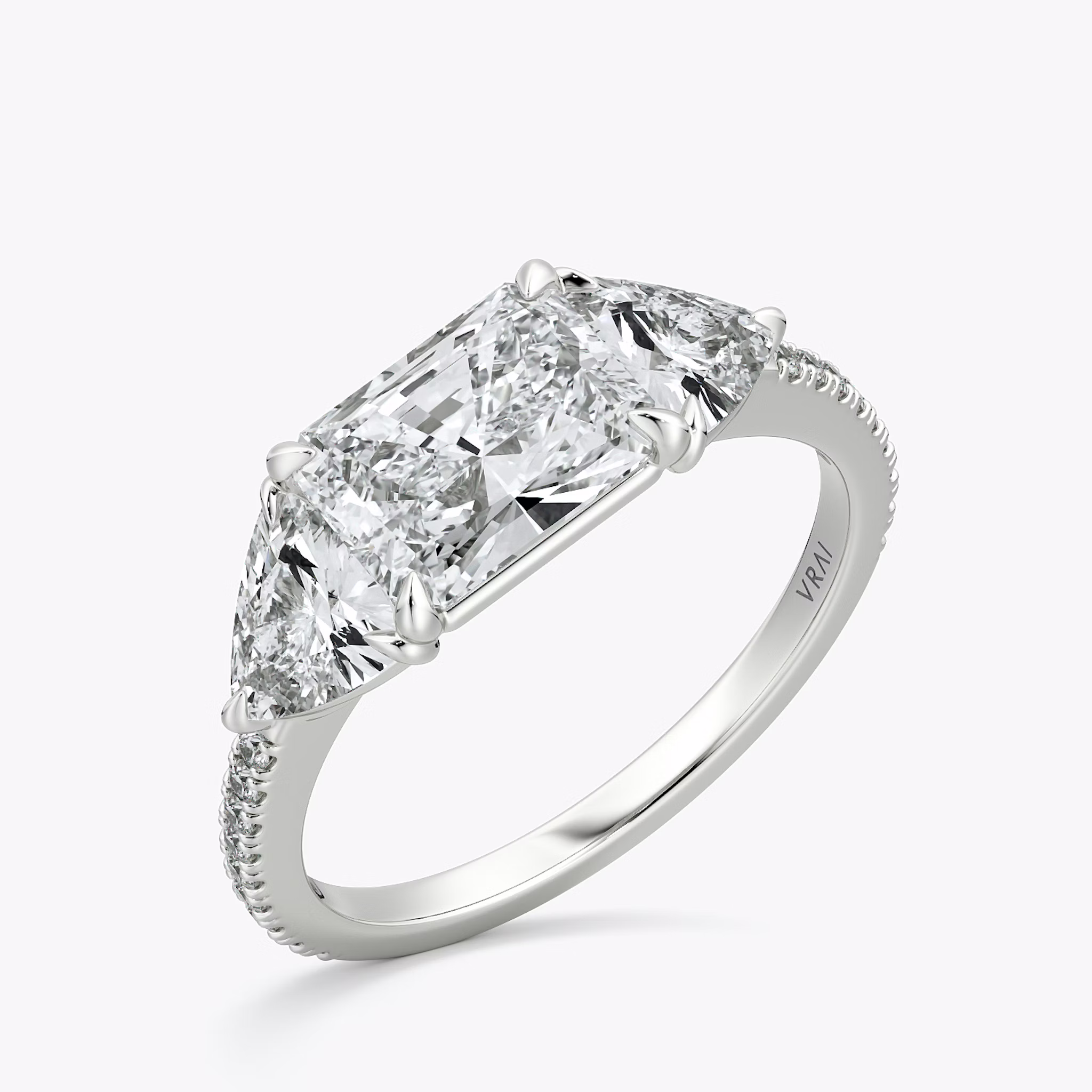 The Three Stone | Radiant | 18k | White Gold | bandAccent: Pavé | diamondOrientation: horizontal | sideStoneCarat: 0.50ct | sideStoneShape: Trillion | caratWeight: other