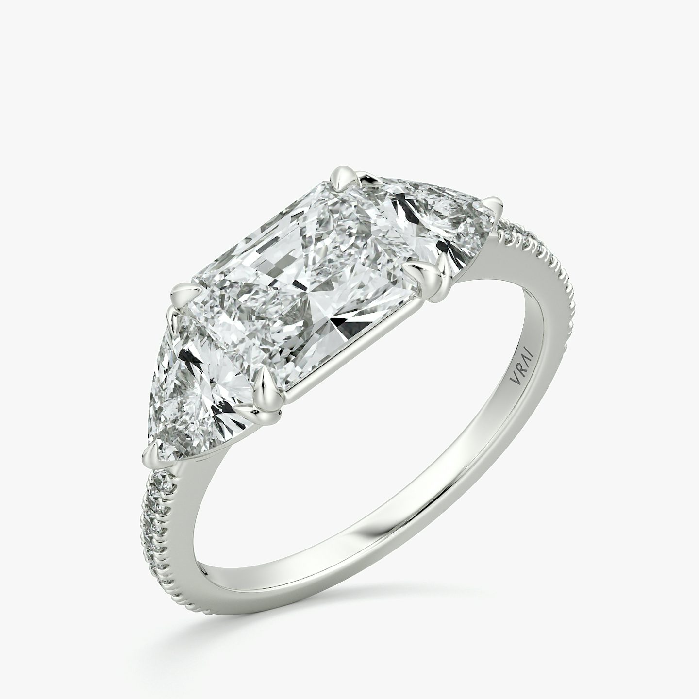 The Three Stone | Radiant | Platinum | bandAccent: Pavé | diamondOrientation: horizontal | sideStoneCarat: 0.50ct | sideStoneShape: Trillion | caratWeight: other