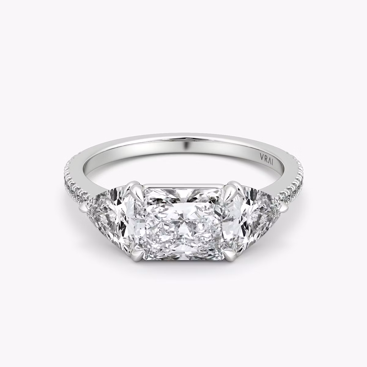 The Three Stone | Radiant | Platinum | bandAccent: Pavé | diamondOrientation: horizontal | sideStoneCarat: 0.50ct | sideStoneShape: Trillion | caratWeight: other