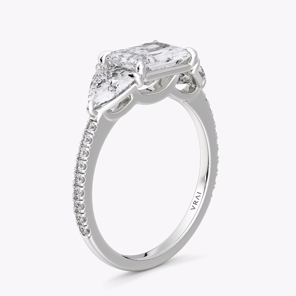The Three Stone | Radiant | Platinum | bandAccent: Pavé | diamondOrientation: horizontal | sideStoneCarat: 0.50ct | sideStoneShape: Trillion | caratWeight: other