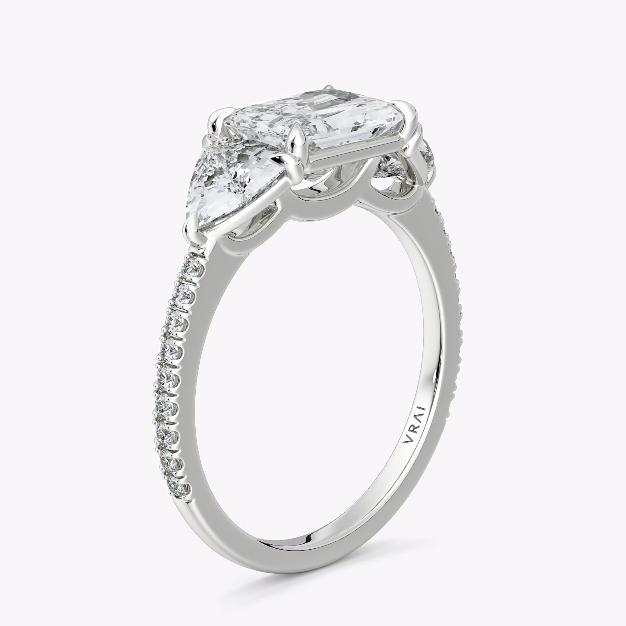 The Three Stone | Radiant | 18k | White Gold | bandAccent: Pavé | diamondOrientation: horizontal | sideStoneCarat: 0.50ct | sideStoneShape: Trillion | caratWeight: other