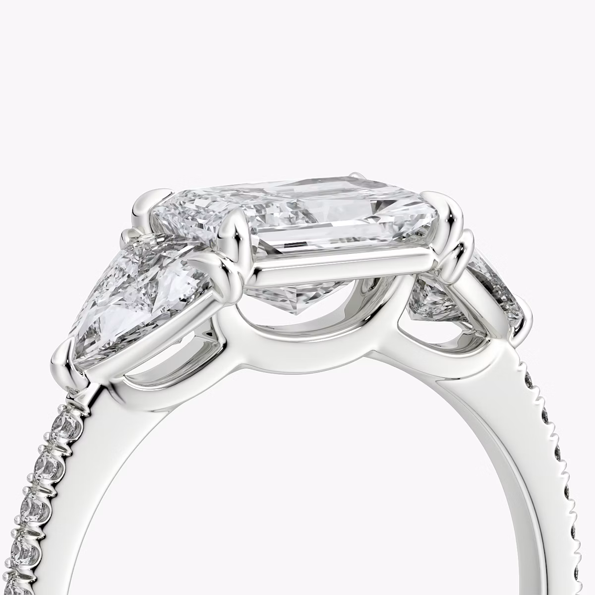 The Three Stone | Radiant | Platinum | bandAccent: Pavé | diamondOrientation: horizontal | sideStoneCarat: 0.50ct | sideStoneShape: Trillion | caratWeight: other