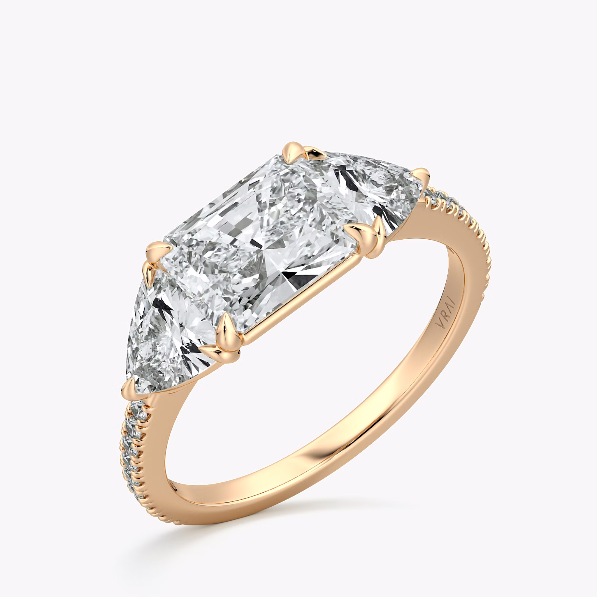 The Three Stone | Radiant | 14k | Rose Gold | bandAccent: Pavé | diamondOrientation: horizontal | sideStoneCarat: 0.50ct | sideStoneShape: Trillion | caratWeight: other