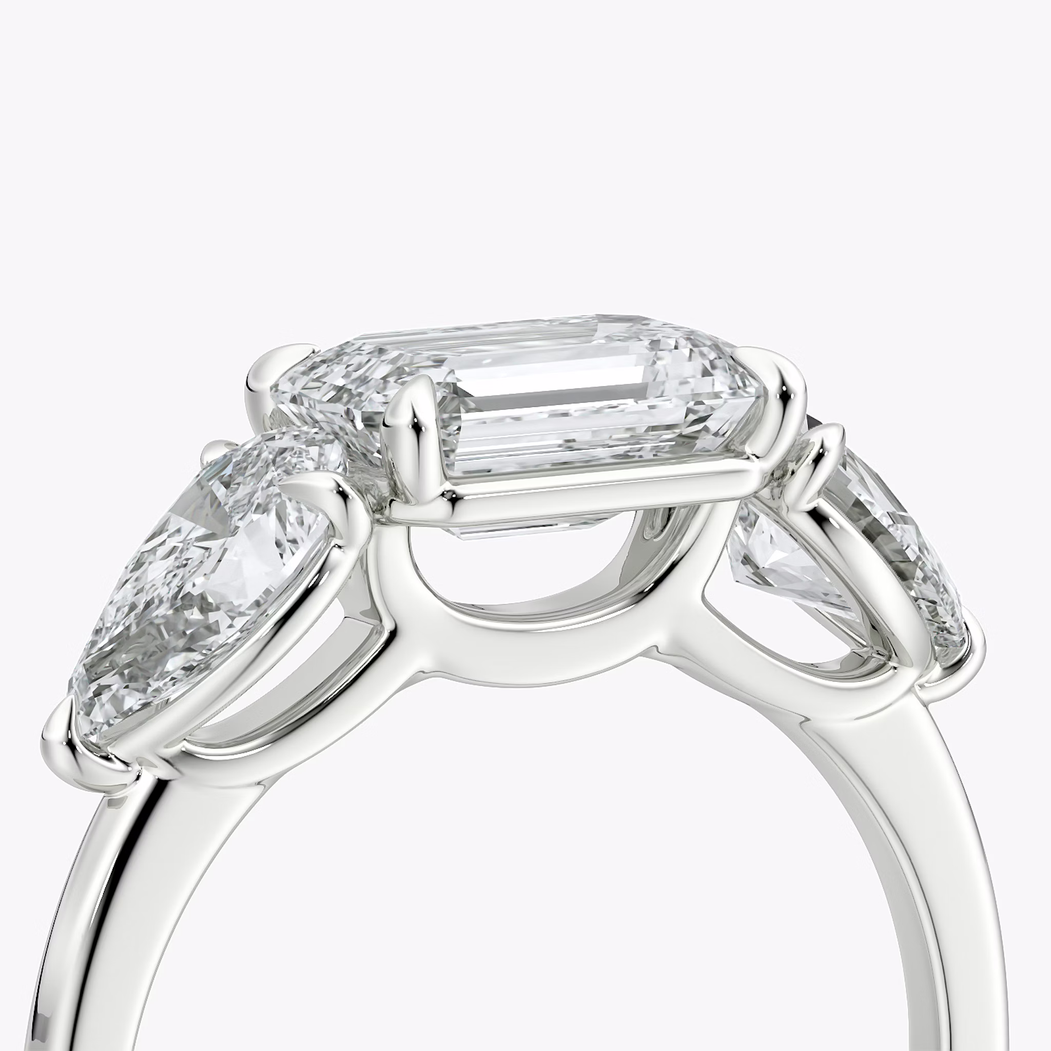The Three Stone | Emerald | Platinum | bandAccent: Plain | diamondOrientation: horizontal | sideStoneCarat: 0.50ct | sideStoneShape: Pear | caratWeight: other