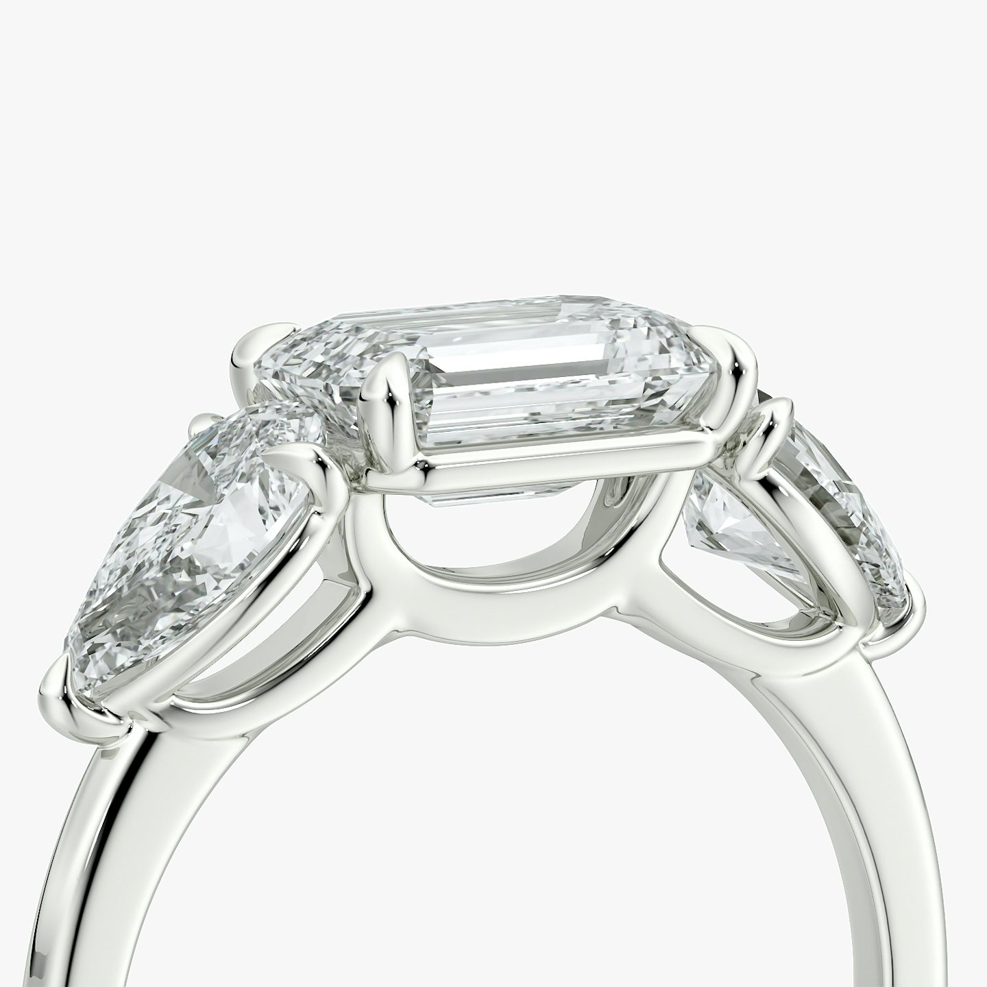 The Three Stone | Emerald | 18k | White Gold | bandAccent: Plain | diamondOrientation: horizontal | sideStoneCarat: 0.50ct | sideStoneShape: Pear | caratWeight: other