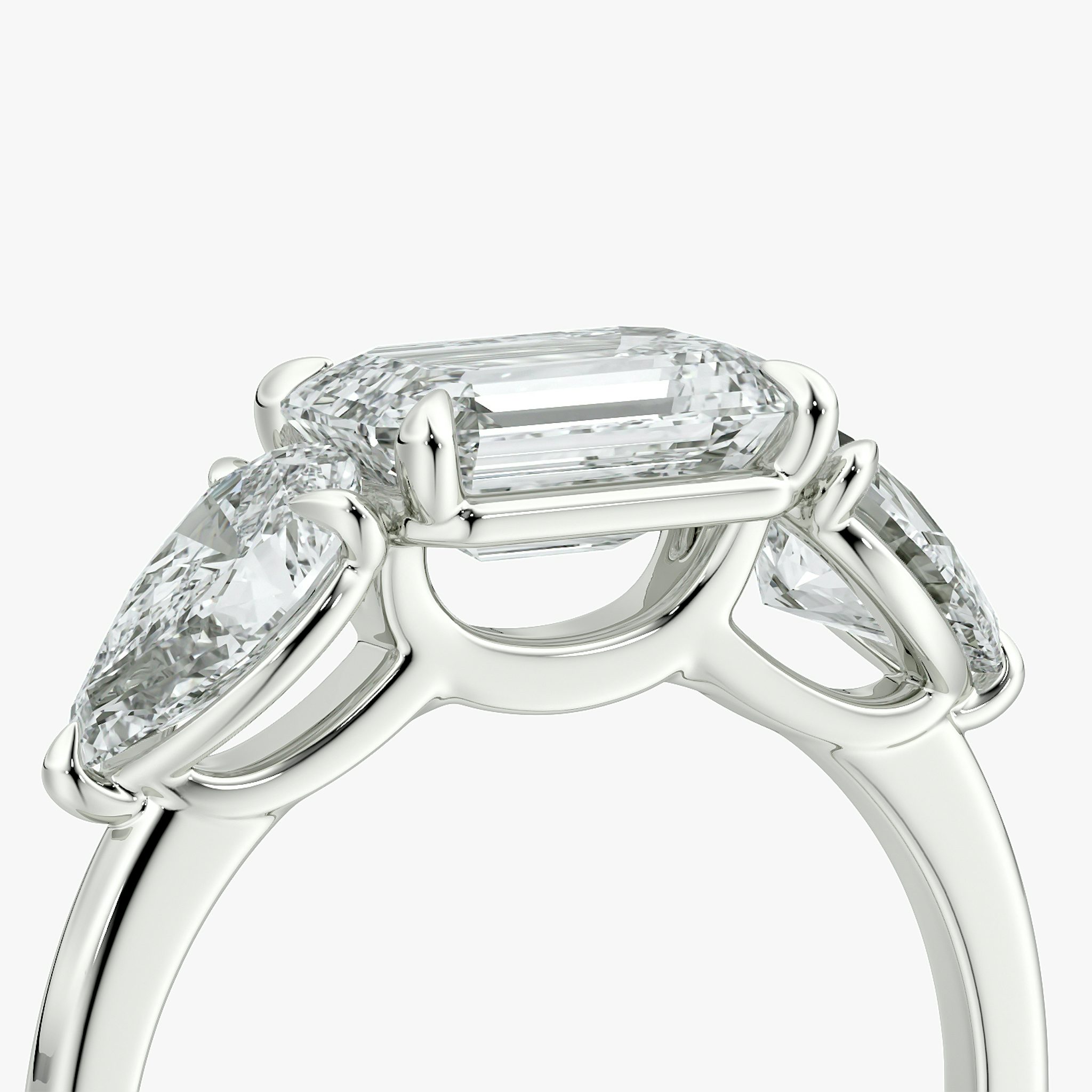 The Three Stone | Emerald | Platinum | bandAccent: Plain | diamondOrientation: horizontal | sideStoneCarat: 0.50ct | sideStoneShape: Pear | caratWeight: other