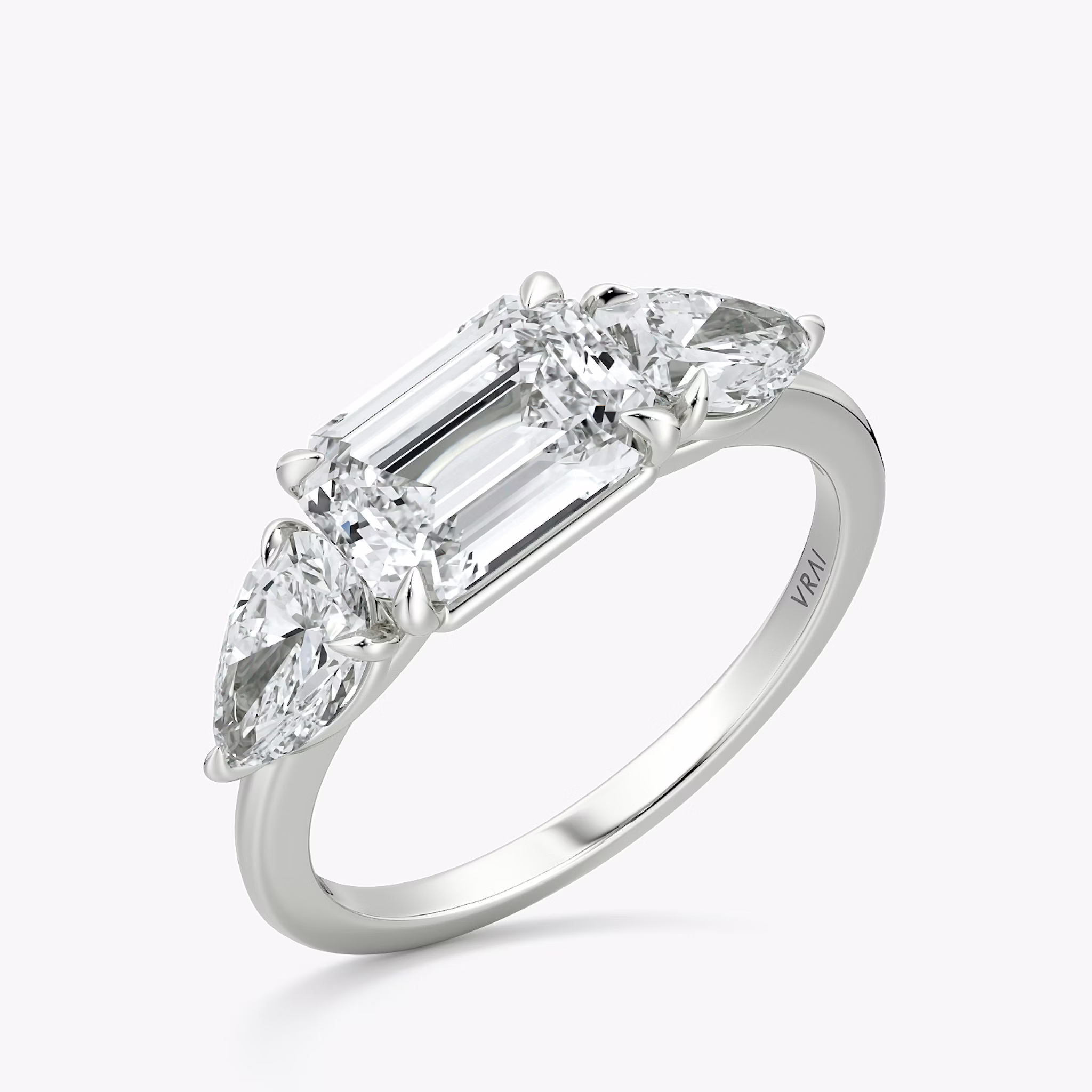 The Three Stone | Emerald | Platinum | bandAccent: Plain | diamondOrientation: horizontal | sideStoneCarat: 0.50ct | sideStoneShape: Pear | caratWeight: other