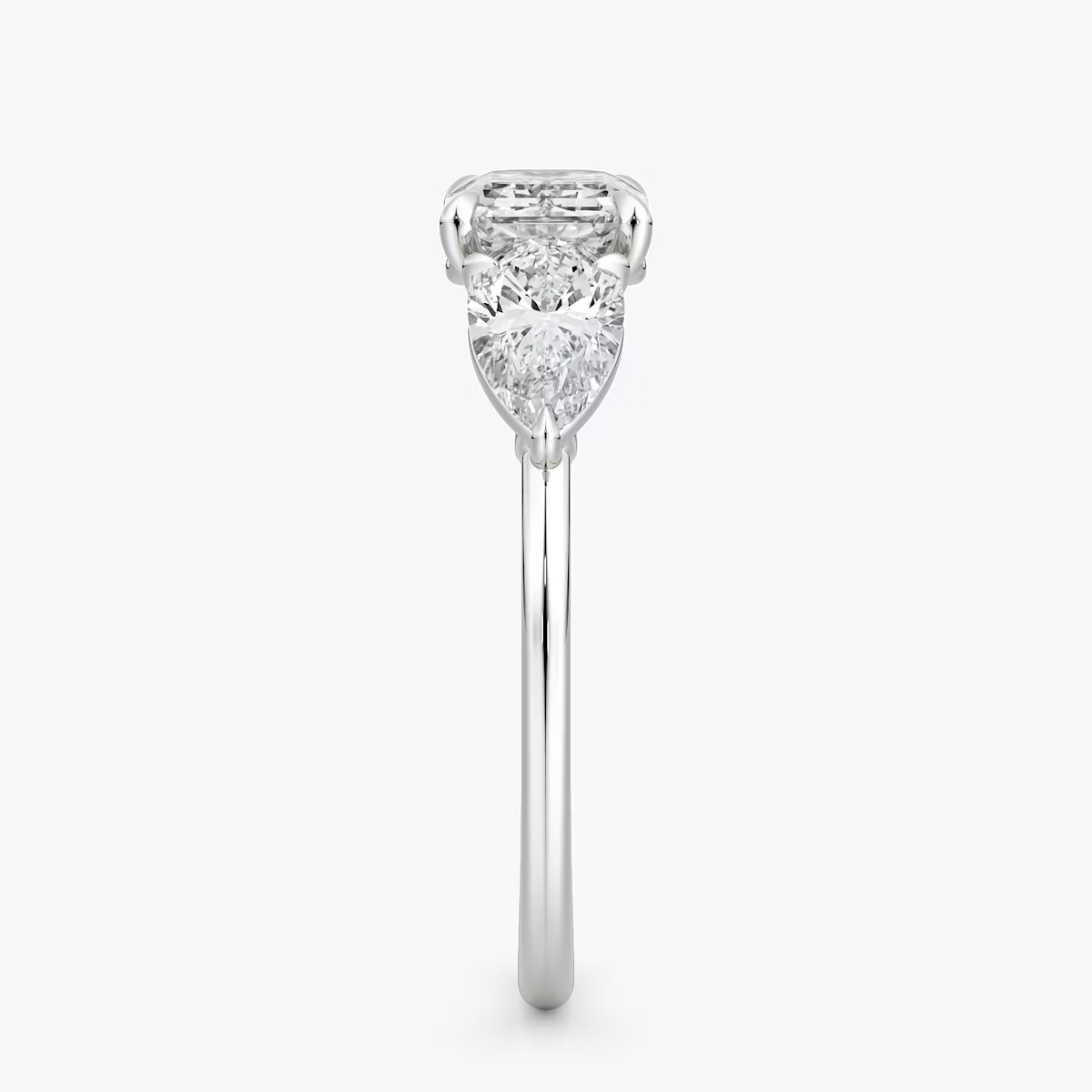 The Three Stone | Emerald | 18k | White Gold | bandAccent: Plain | diamondOrientation: horizontal | sideStoneCarat: 0.50ct | sideStoneShape: Pear | caratWeight: other