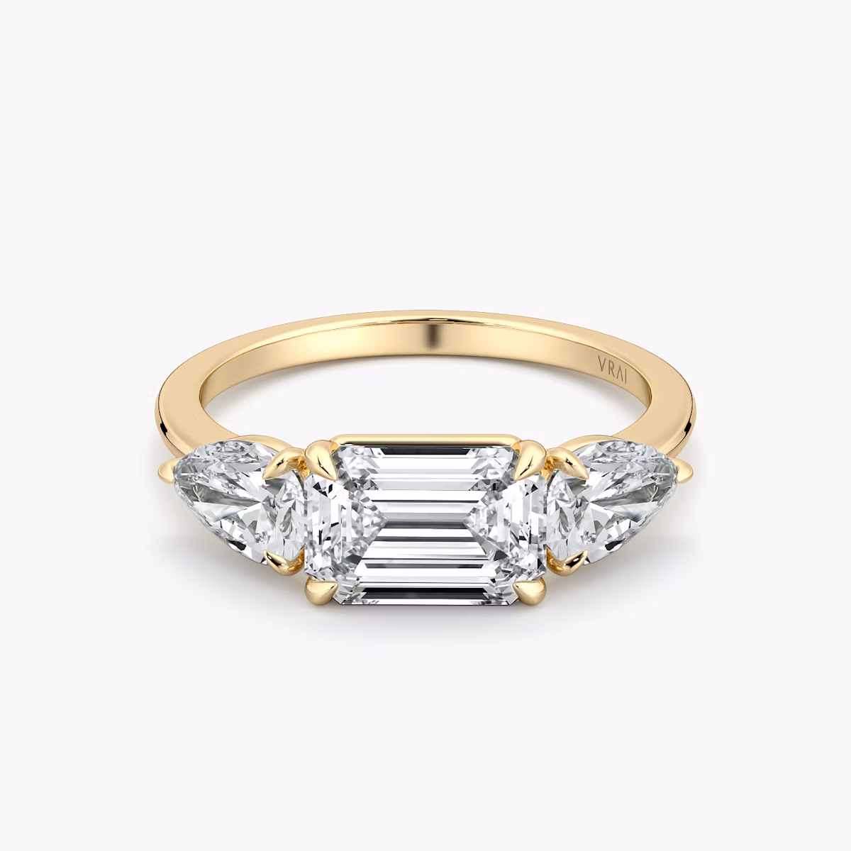 The Three Stone | Emerald | 18k | Yellow Gold | bandAccent: Plain | diamondOrientation: horizontal | sideStoneCarat: 0.50ct | sideStoneShape: Pear | caratWeight: other